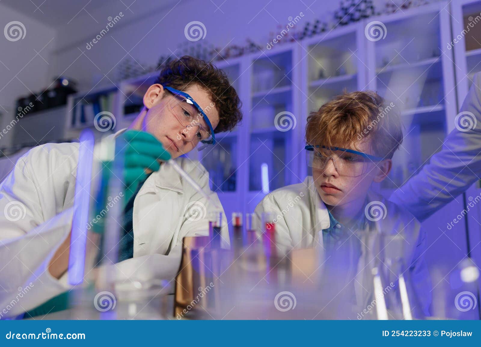 Science Students Doing Chemical Experiment in the Laboratory at