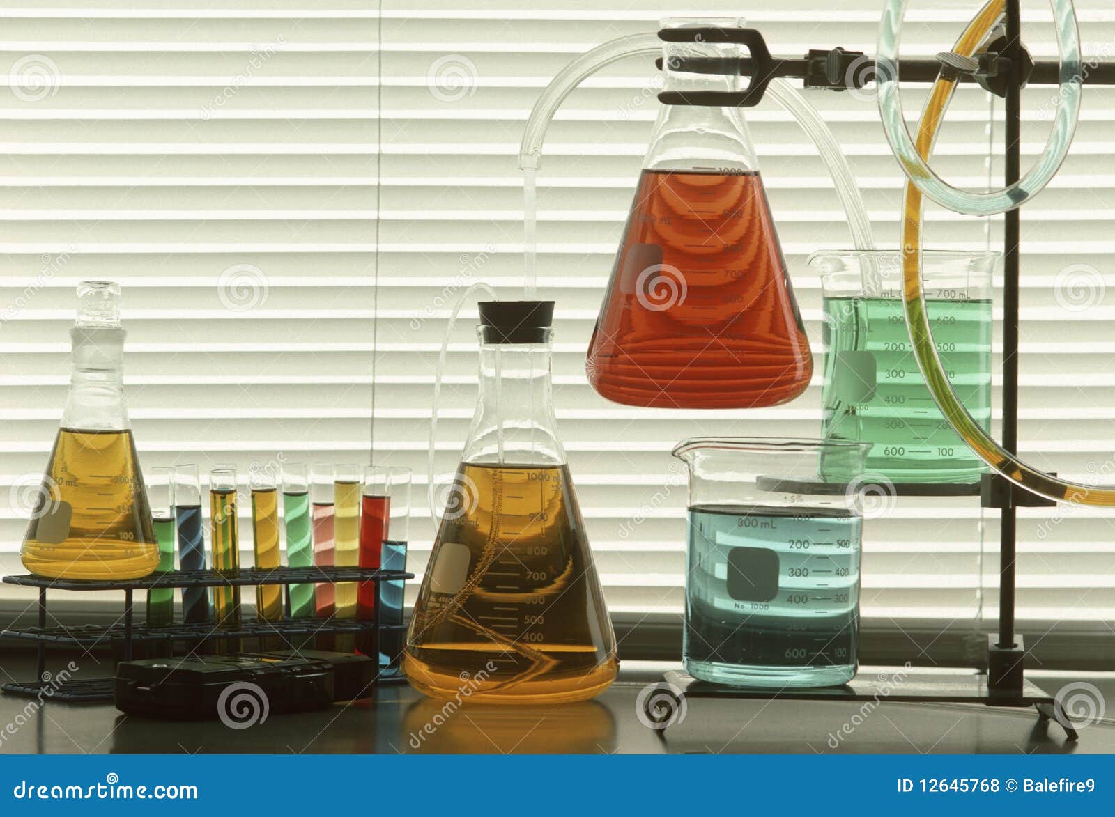 scientific glassware with colored liquids