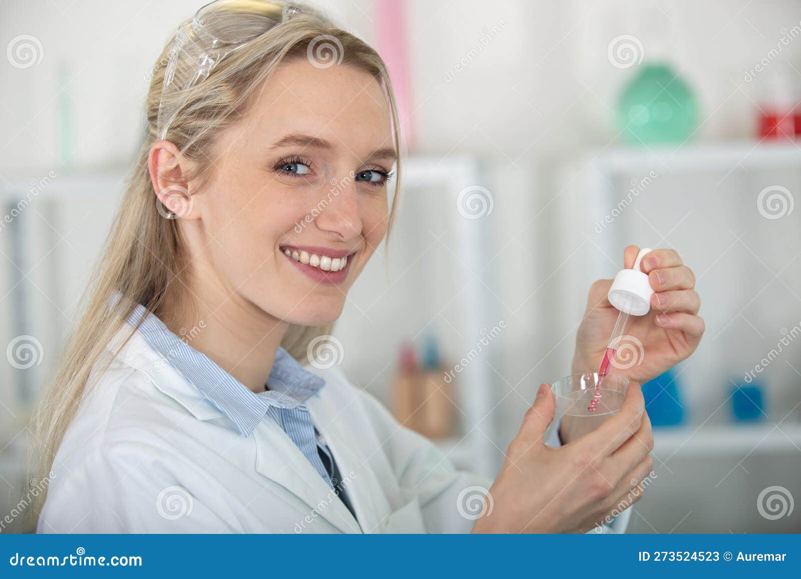 Scientist Dropping Liquid from Pipette Onto Petri Dish Stock Image