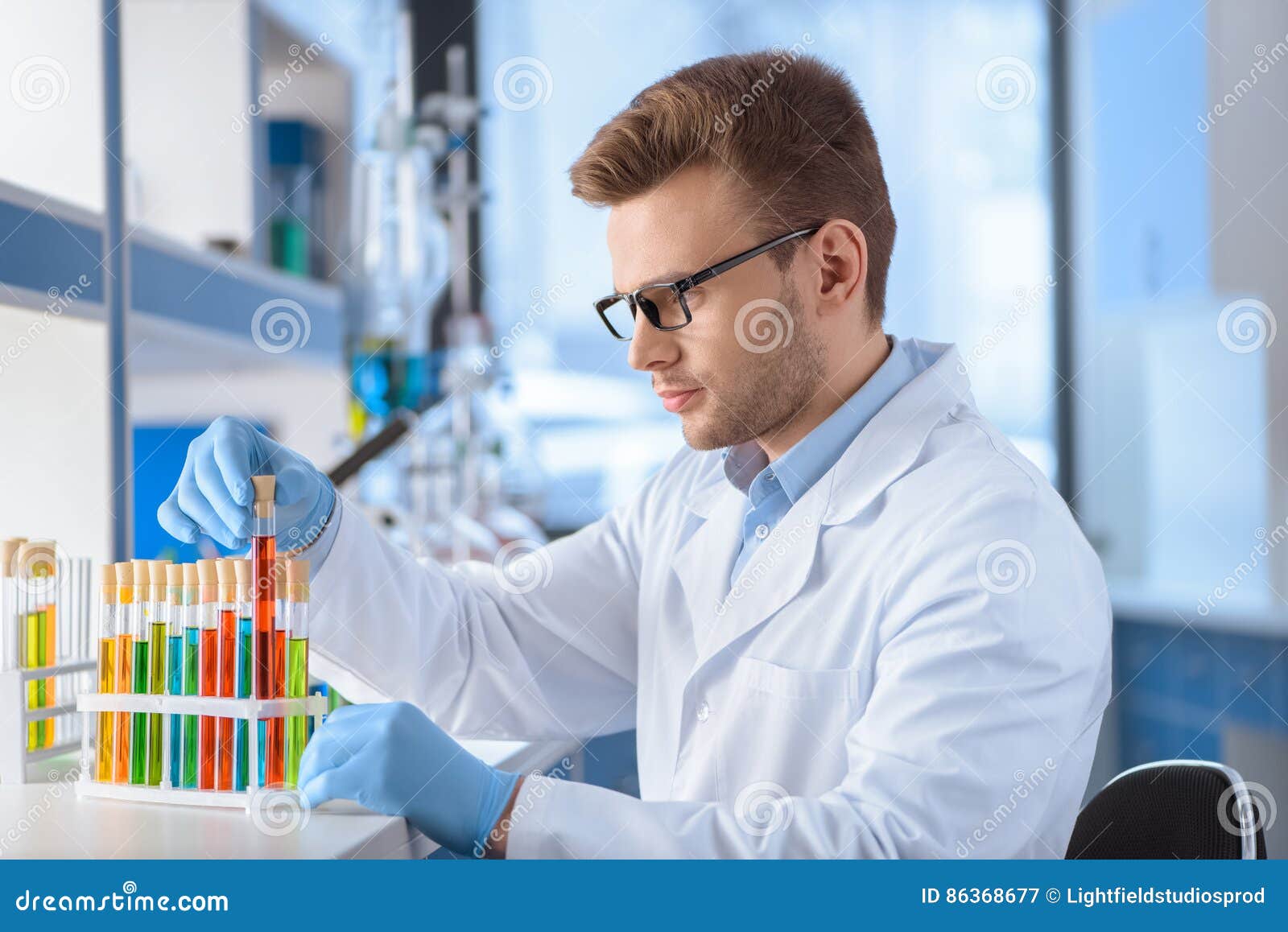 Scientist in Eyeglasses Working with Test Tubes in Lab Stock Image