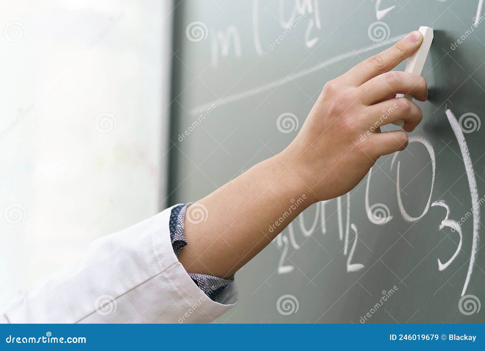 Scientist Hand with a Chalk Writing a Chemical Equation Stock Image
