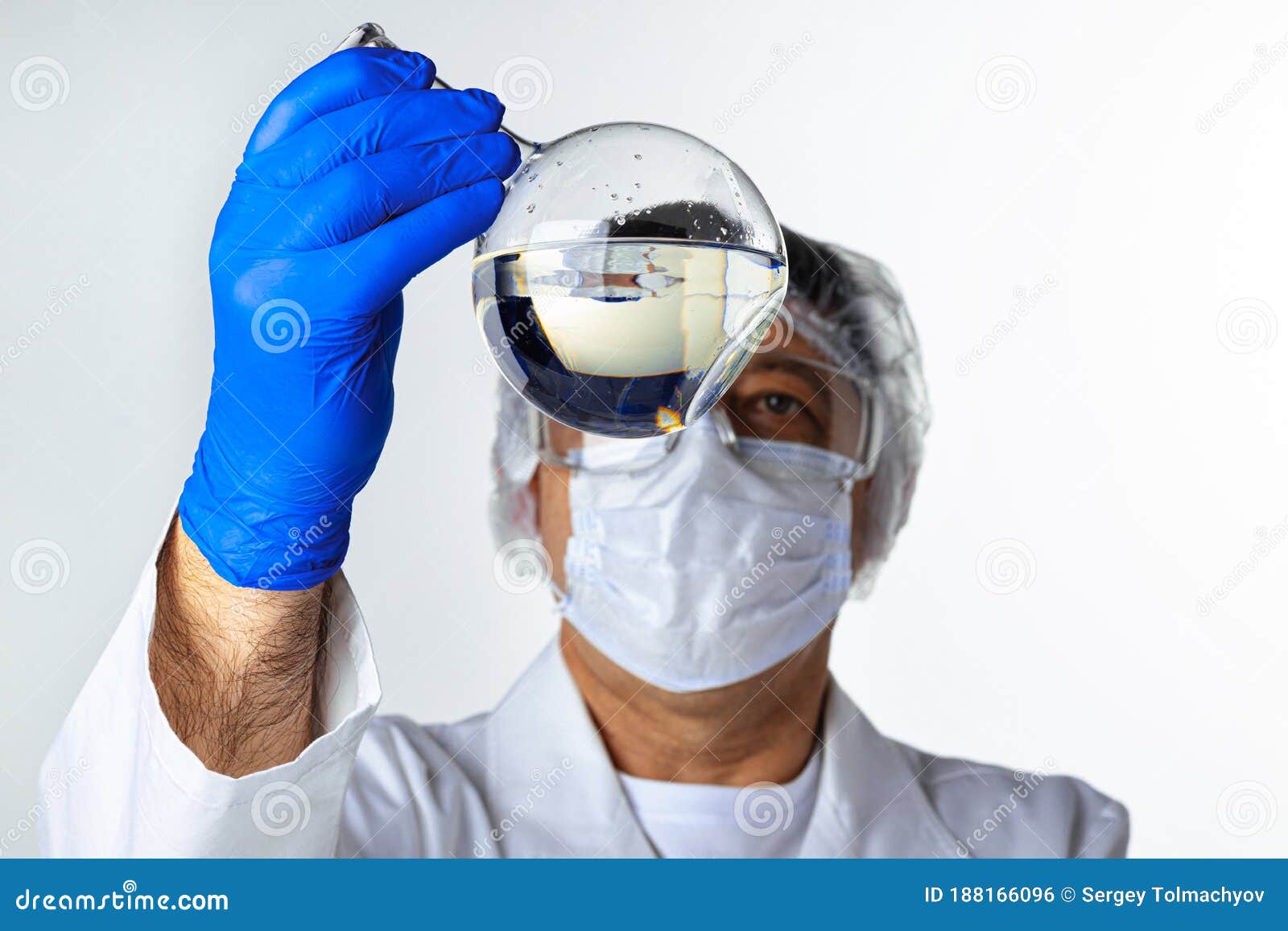 Scientist Hands Holding Some Liquid in a Glassware in Laboratory for