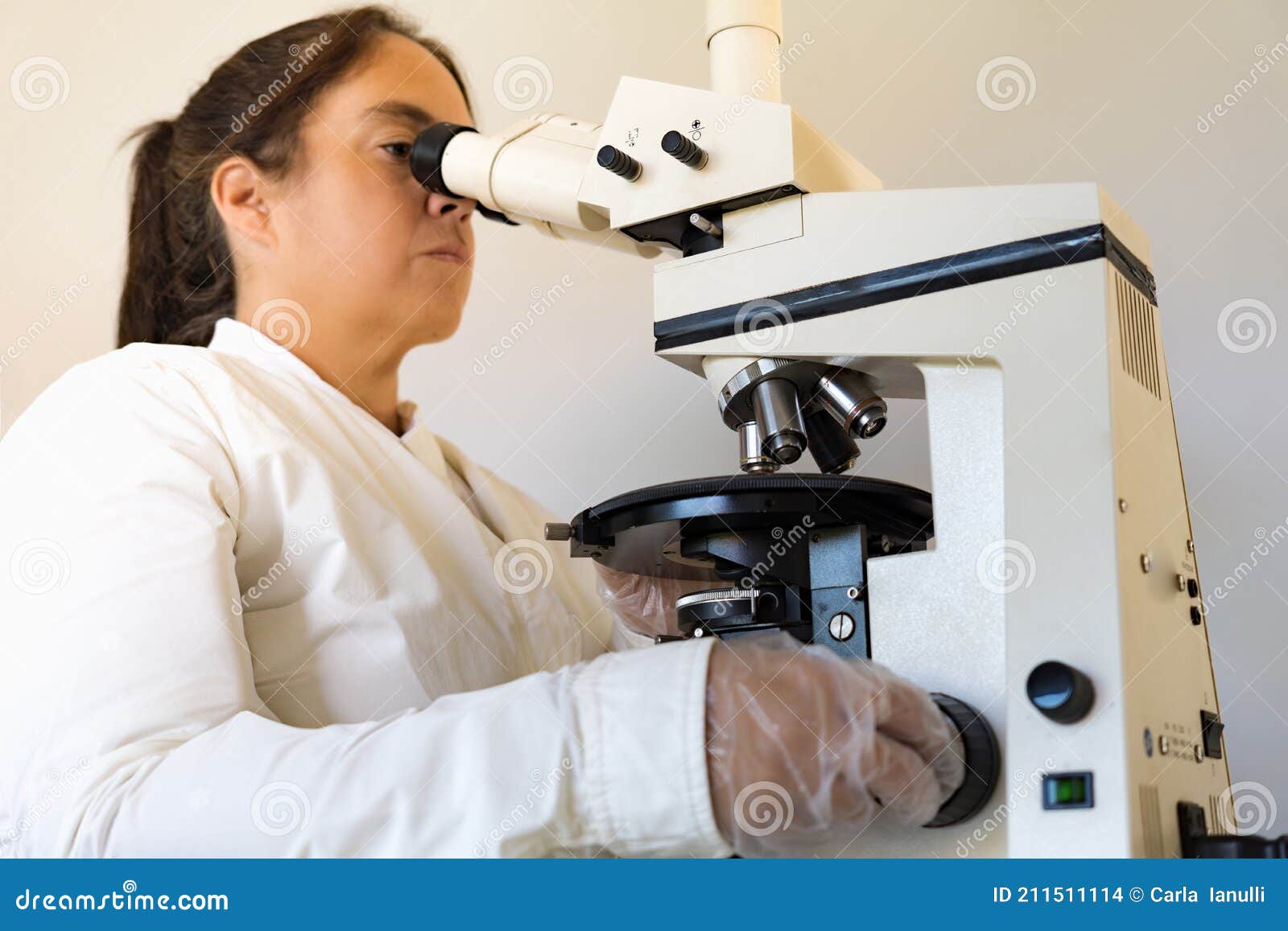 scientist looking through the microscope