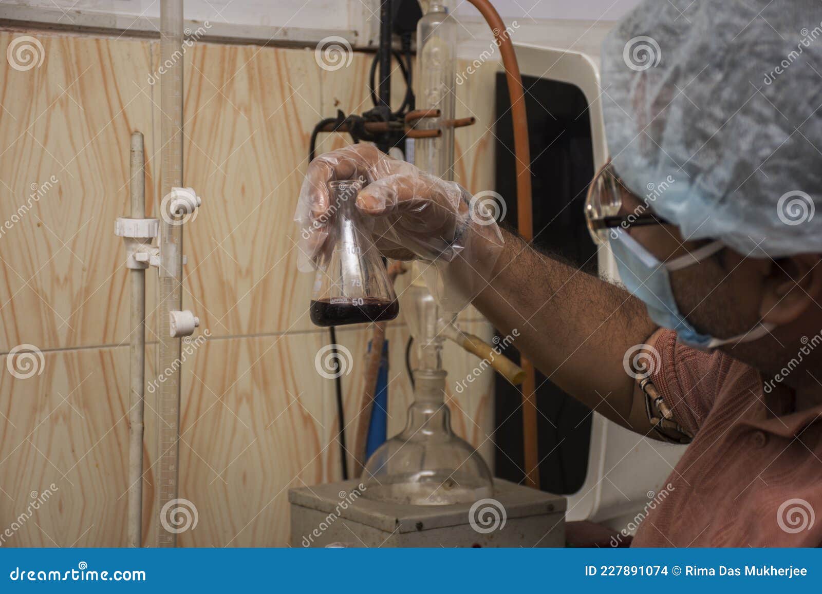A Scientist Holding a Solution in Test Tube for Testing Bacteria and