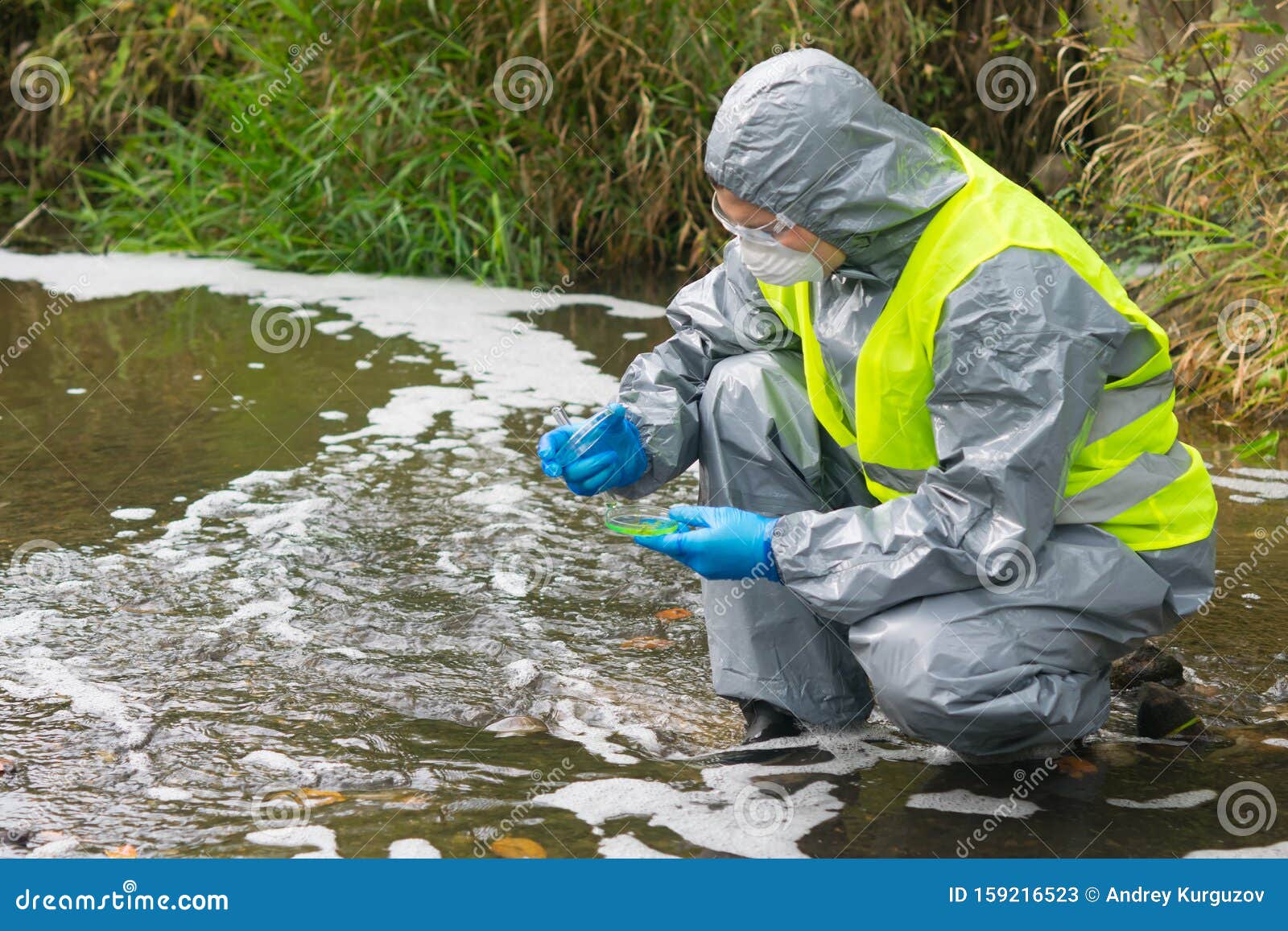 Scientist In A Protective Suit And Mask, Collects ...