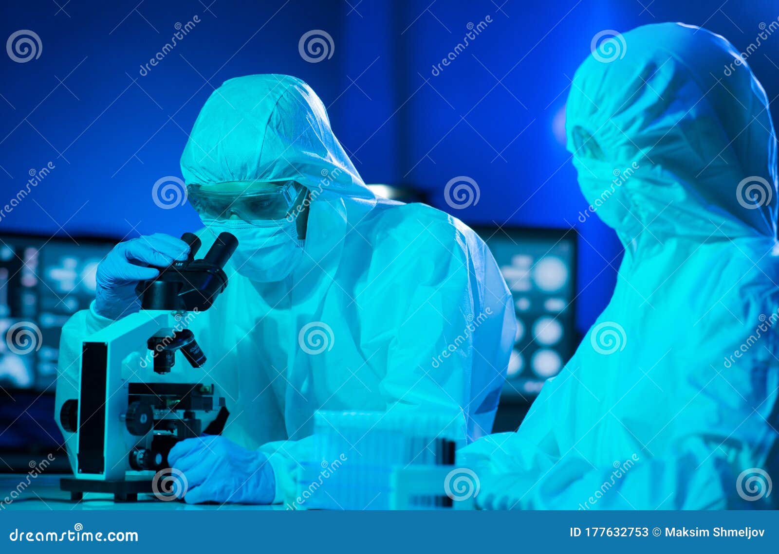 Scientists In Protection Suits And Masks Working In Research Lab Using ...