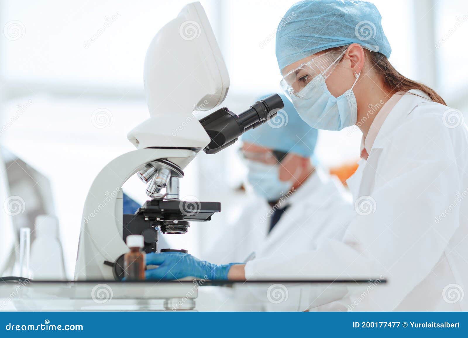 Scientists Testing the Liquid and Writing the Results in a Laboratory