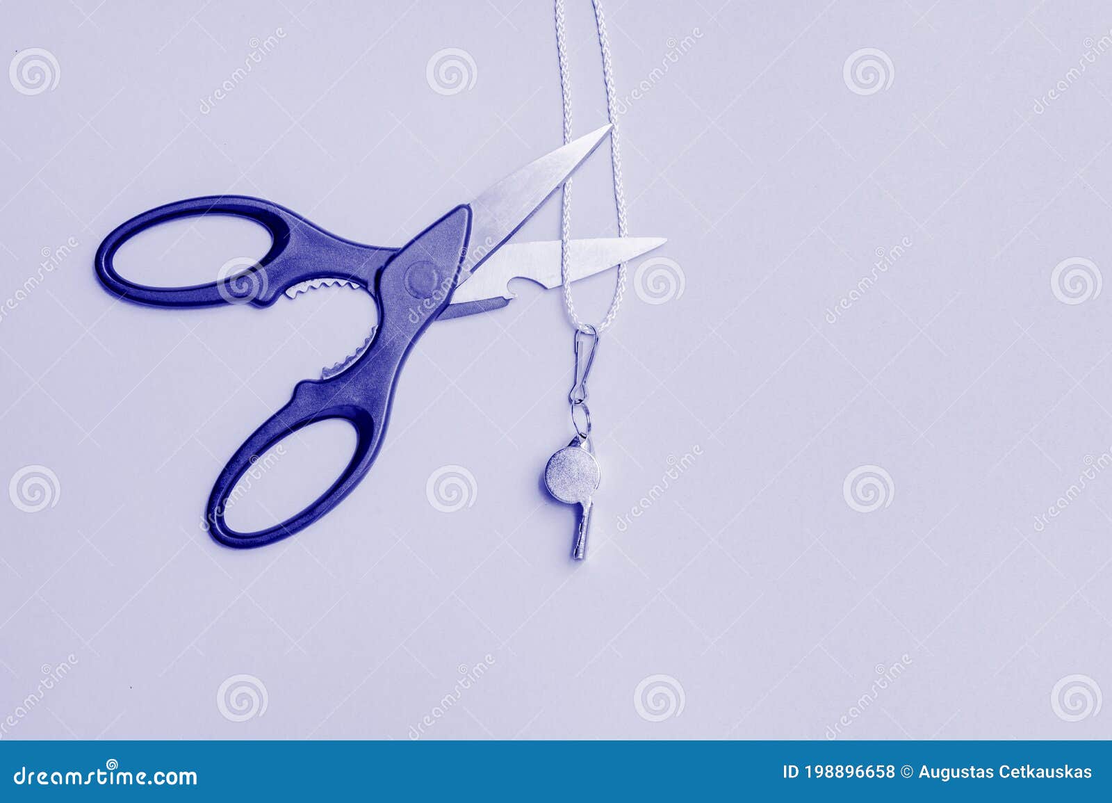 scissors cut a whistle. caught an unscrupulous sports referee concept. blue color filter