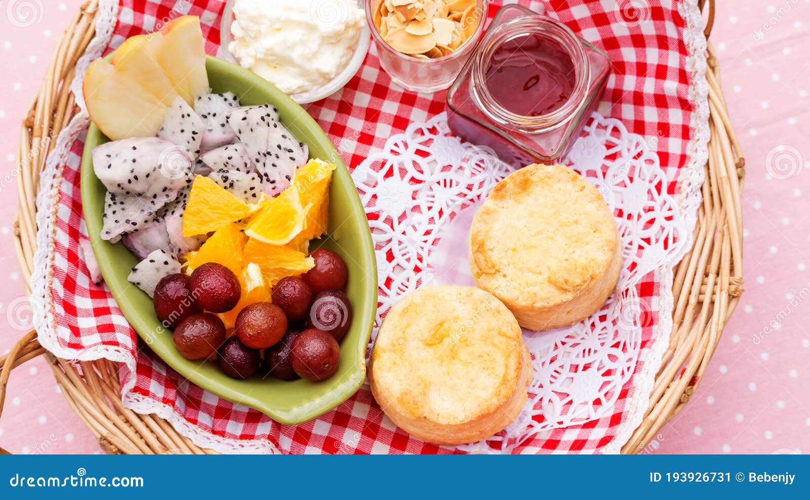 Scone, Strawberry Jam, Almond, and Mixed Fruit in a Basket Stock Image