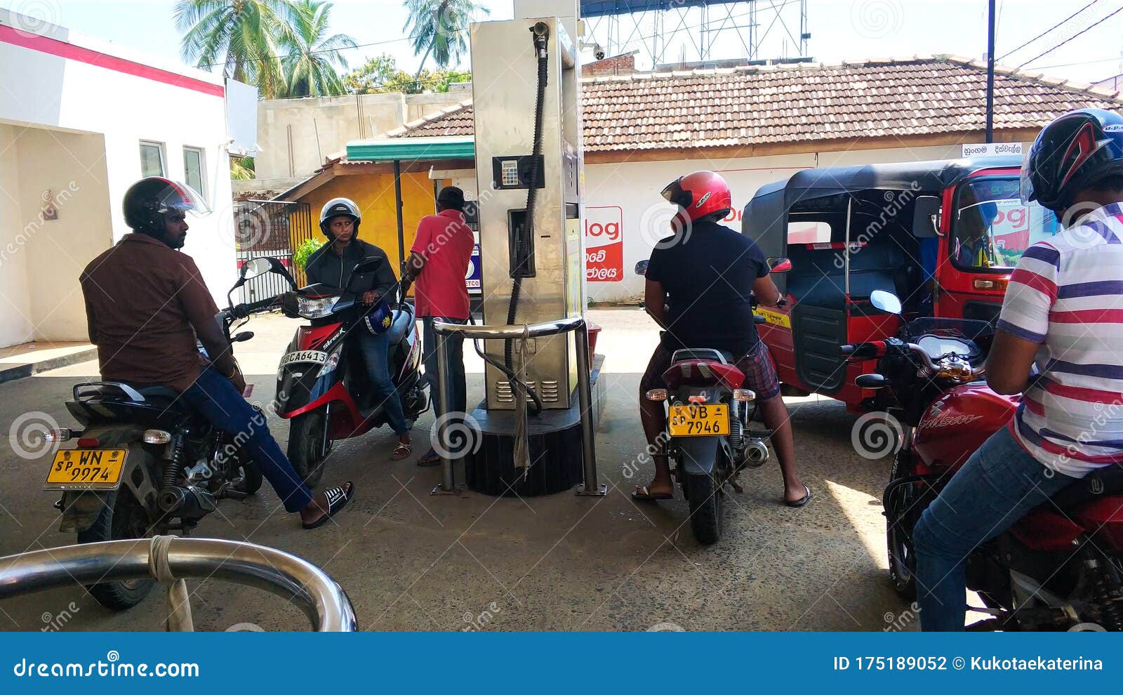 Scooters are Refueled at a Gas Station in Sri Lanka Editorial