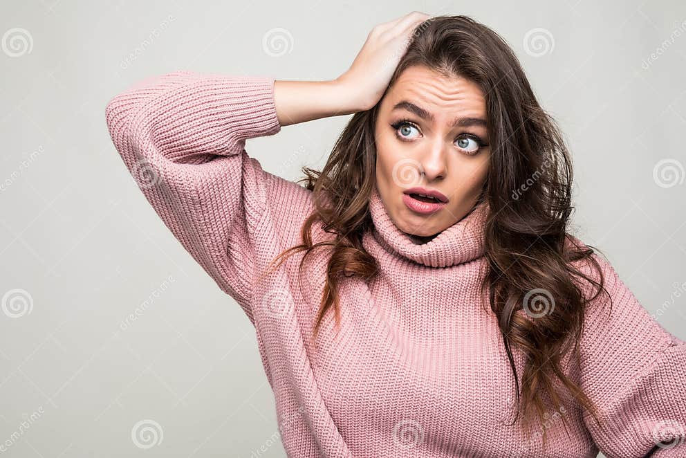 Scowling Young Woman Scratching Her Head Isolated On White Stock Image