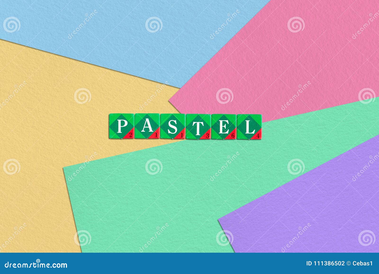 scrabble letters spelling pastel on colorful paper background