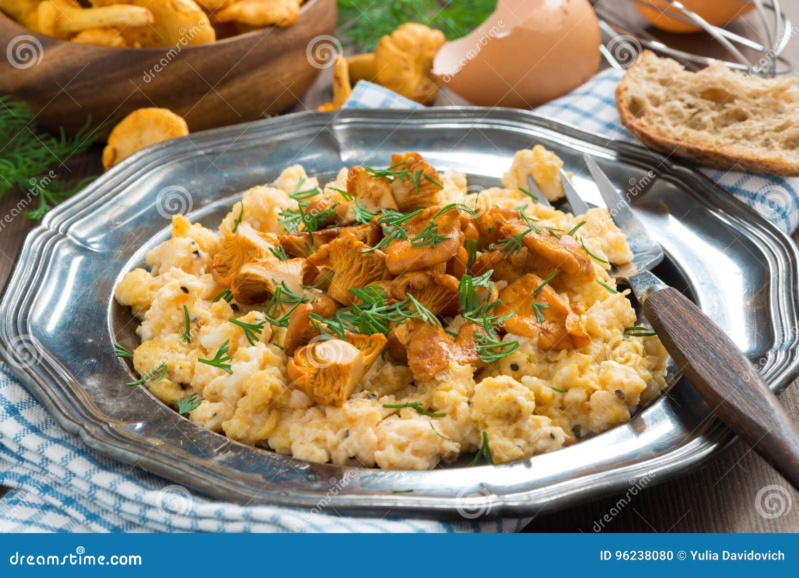 Scrambled Eggs with Chanterelles and Fresh Dill on a Plate Stock Photo