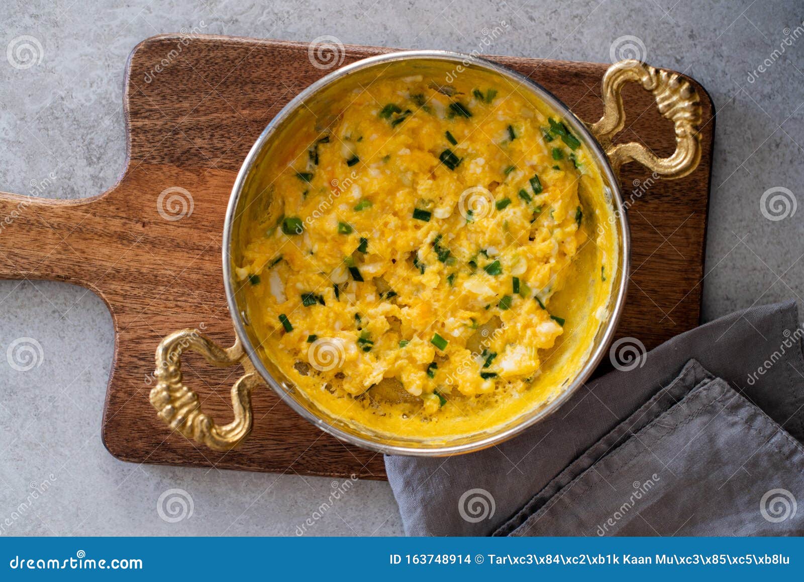 Scrambled Eggs with Cheese and Spring Onion. Served in a Copper Pan