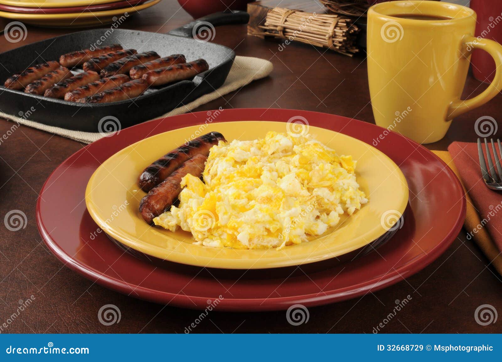 Scrambled eggs and sausage stock image. Image of iron 32668729