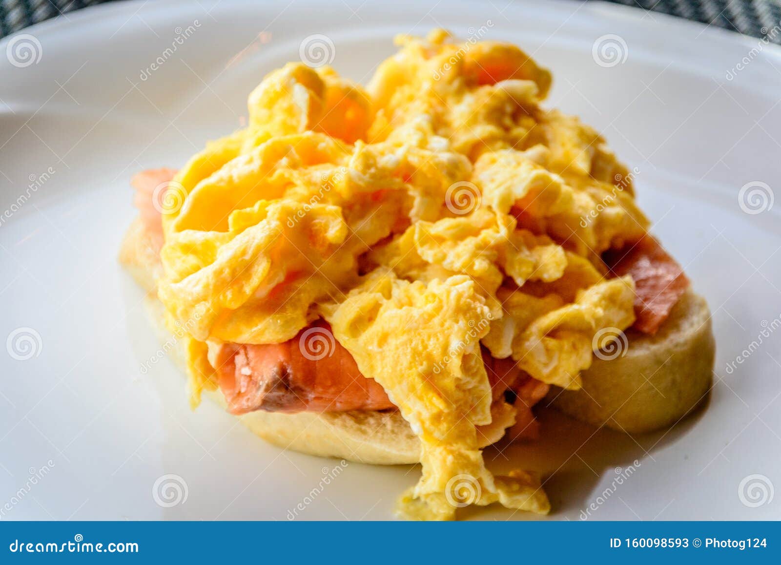 Scrambled Eggs on Smoked Salmon and Baguette Served on a White China