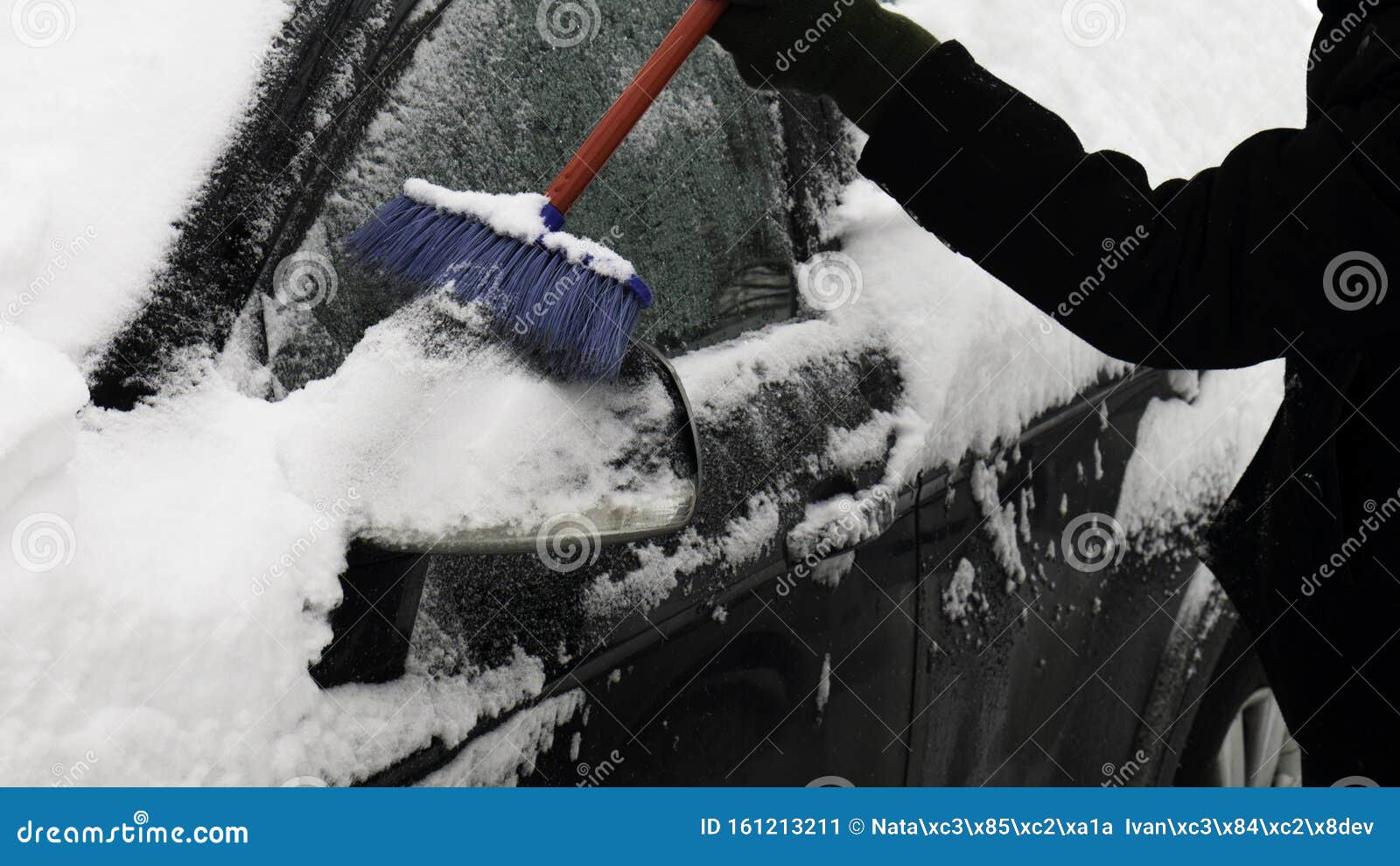 Scraping the Snow of a Car`s Wing Mirror and Side Windows Using the