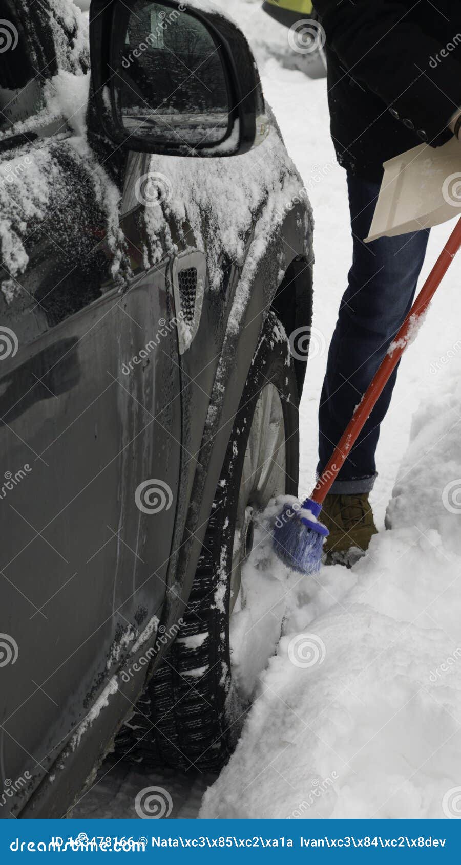 Scraping the Snow of a Car Using the Brush. Stock Photo Image of