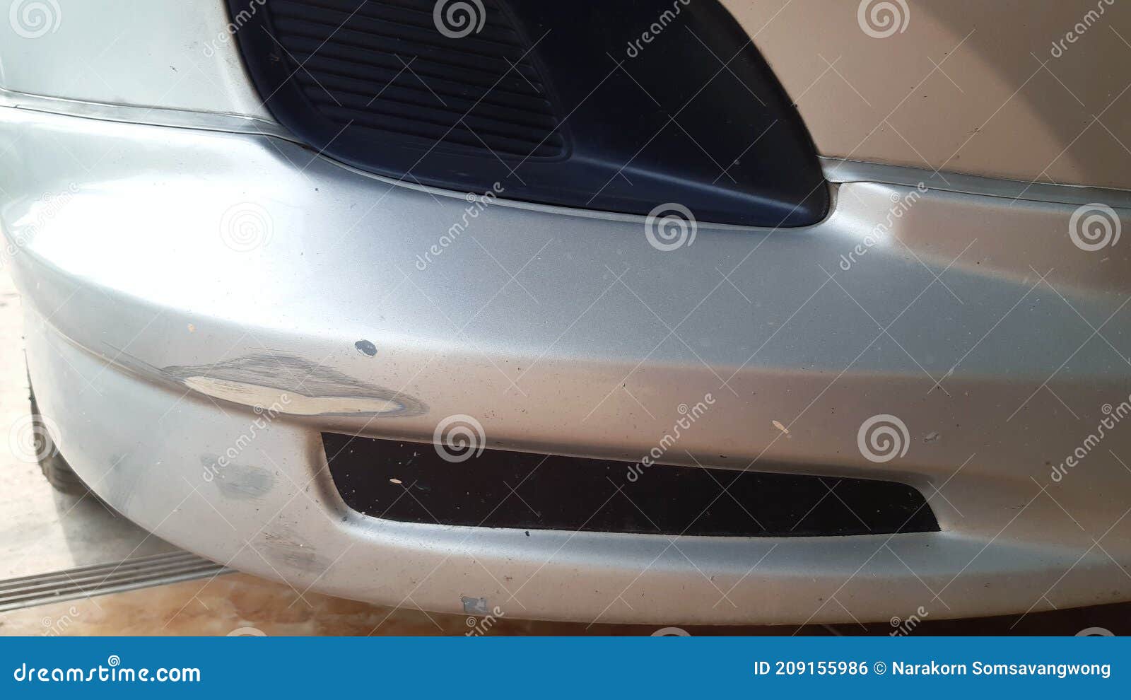 scrath abrasion on car front bumper due to minor accident.