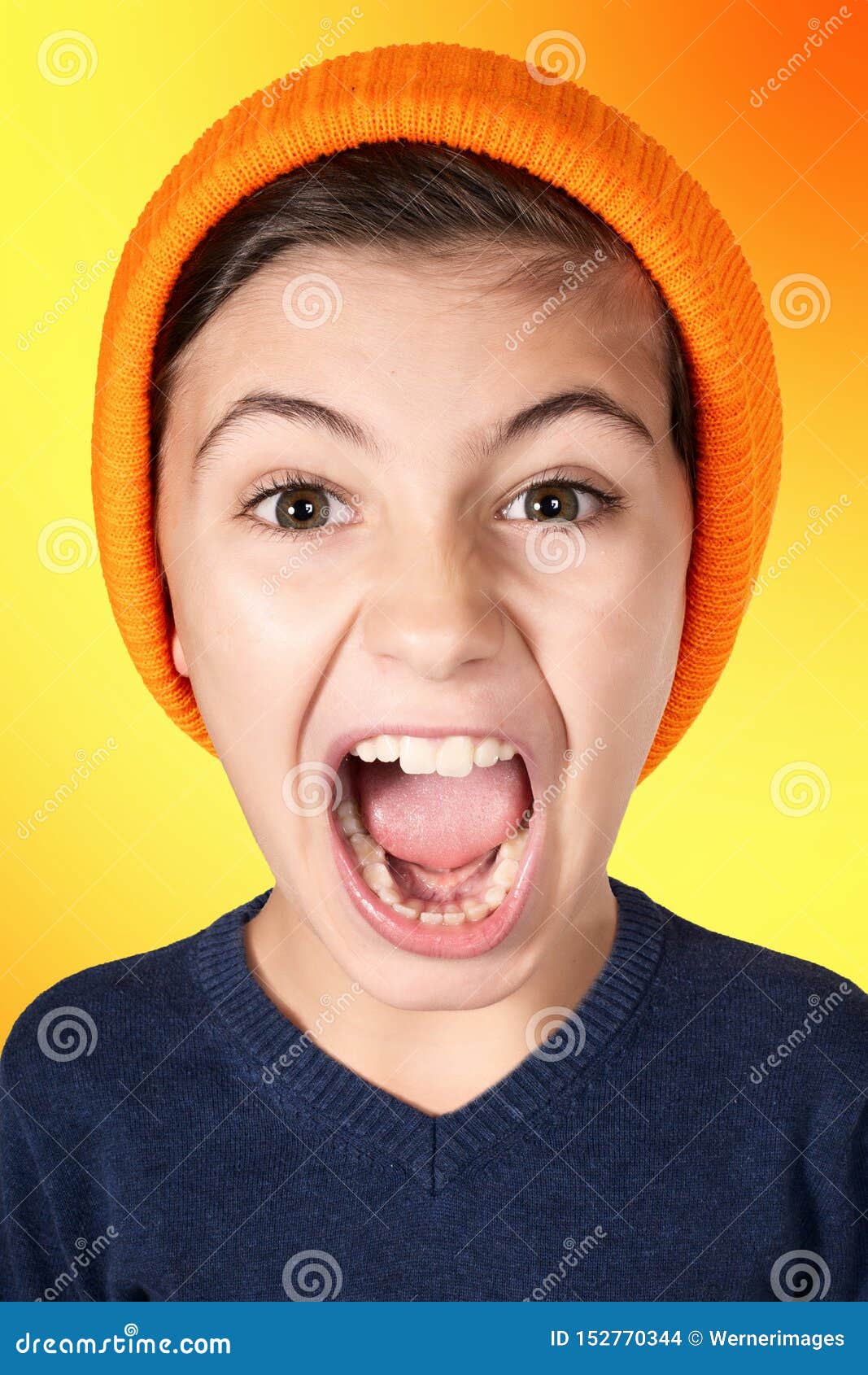 Screaming Young Boy with Big Head on Orange Background Stock Photo