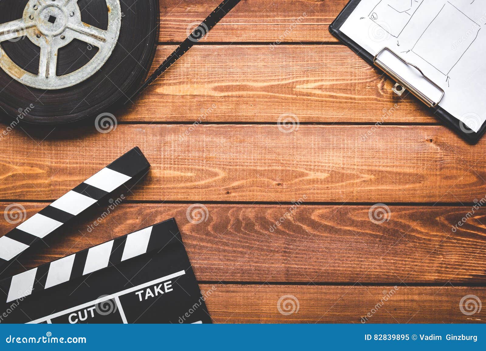 screenwriter desktop with movie clapper board wooden background top view