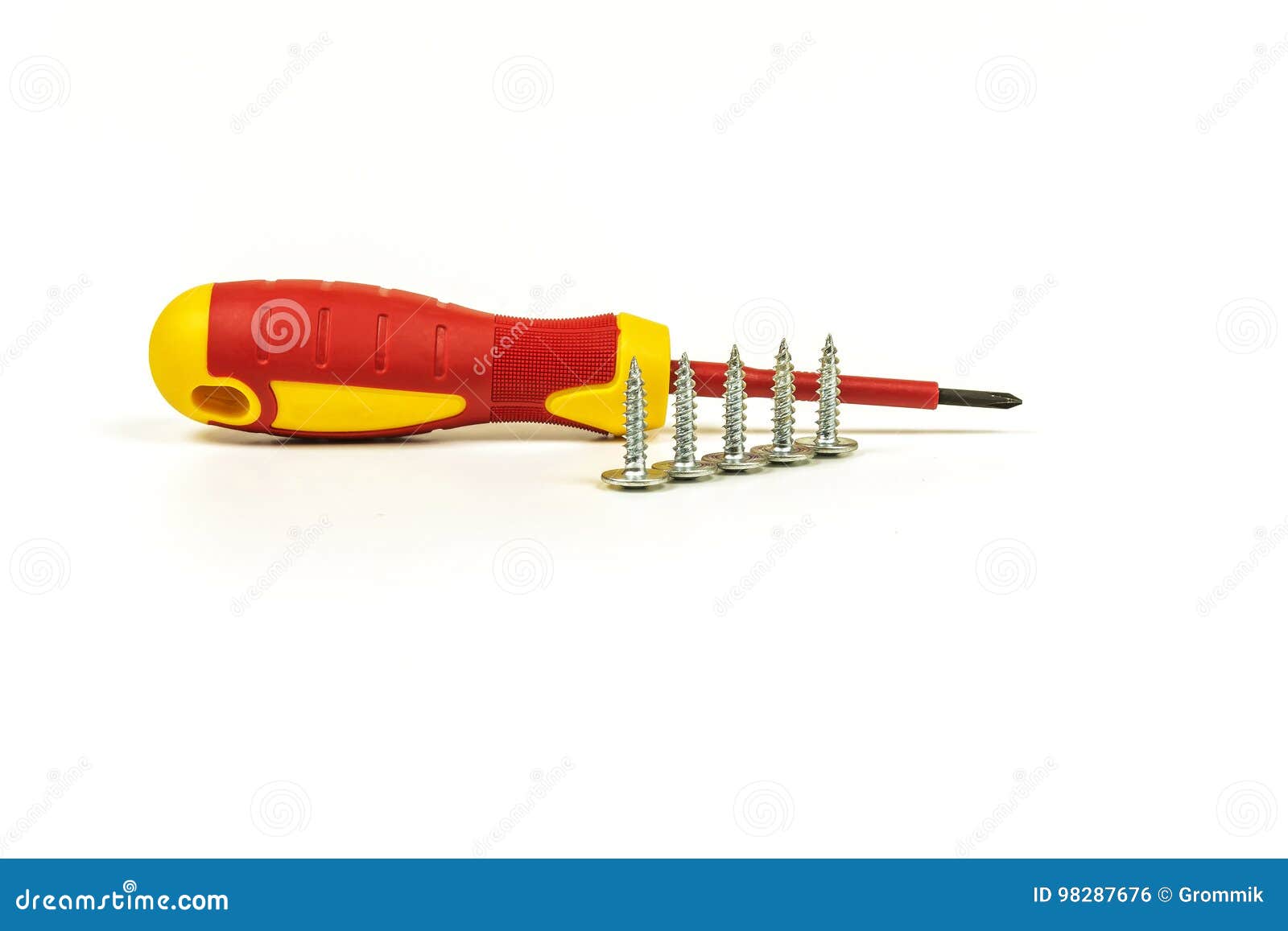 screwdriver and self-tapping screws lie on a light back