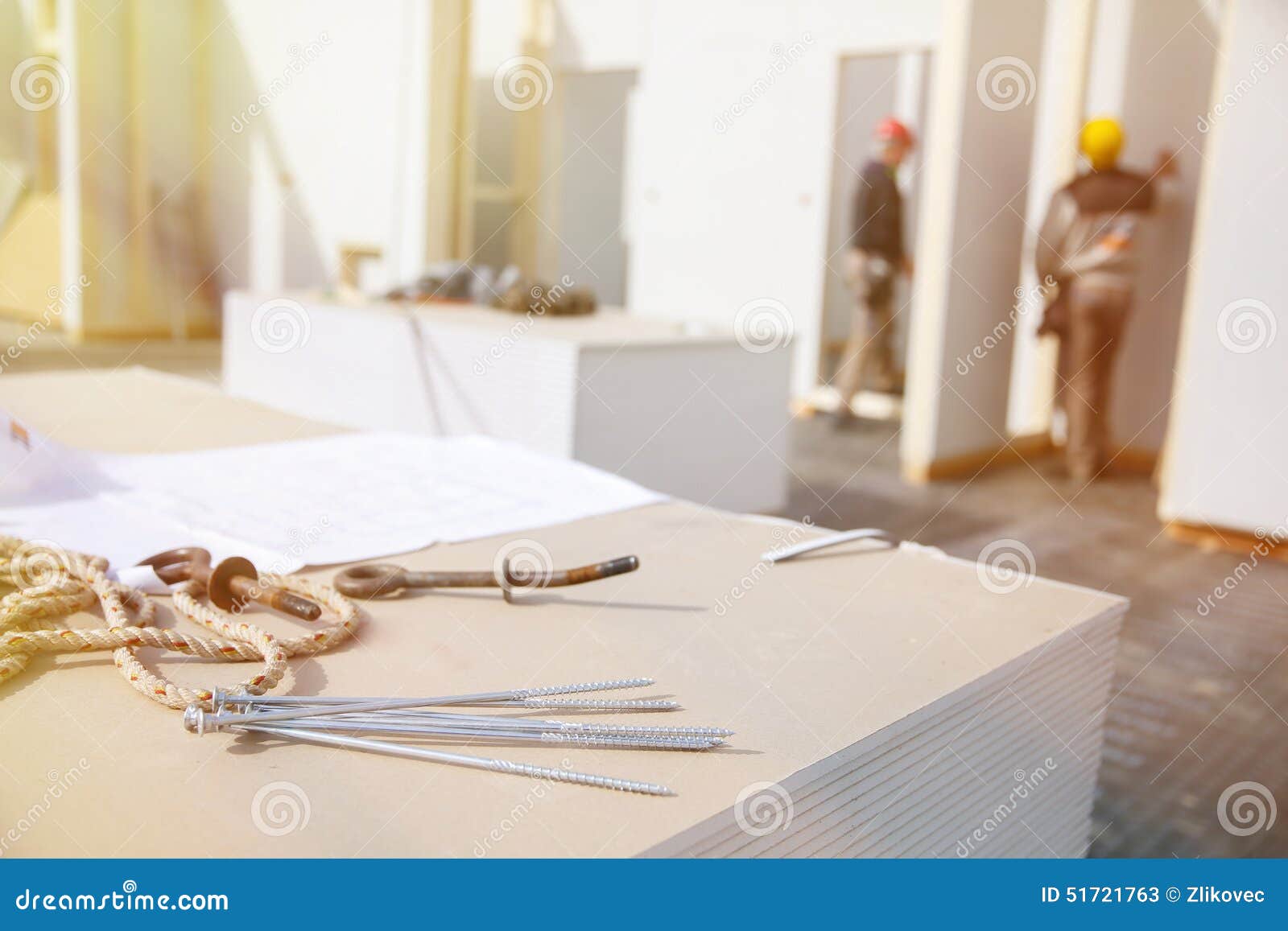 screws on plasterboard panels with workers