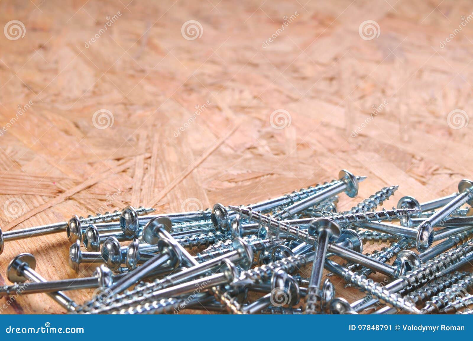 Screws on the wooden table stock image. Image of black 97848791