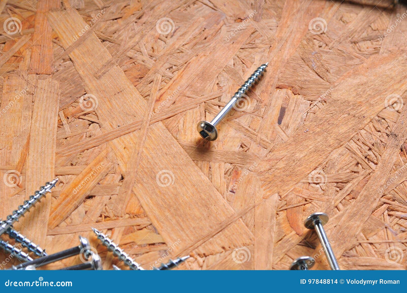 Screws on the wooden table stock photo. Image of closeup 97848814