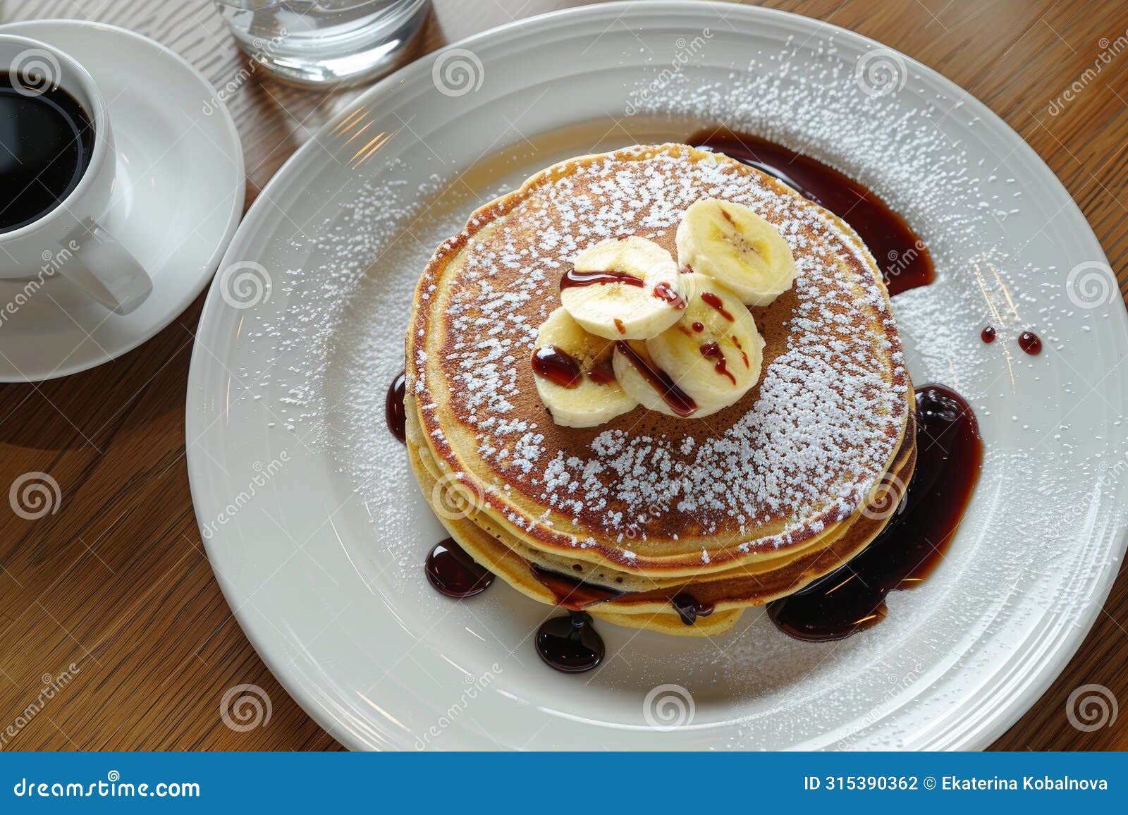 scrumptious chocolate pancakes with a ripe banana elegantly arranged on a white plate, top view