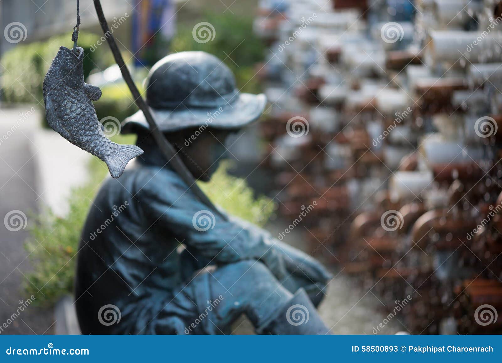 Sculpture of Little Boy Fishing in the Garden. Editorial Stock