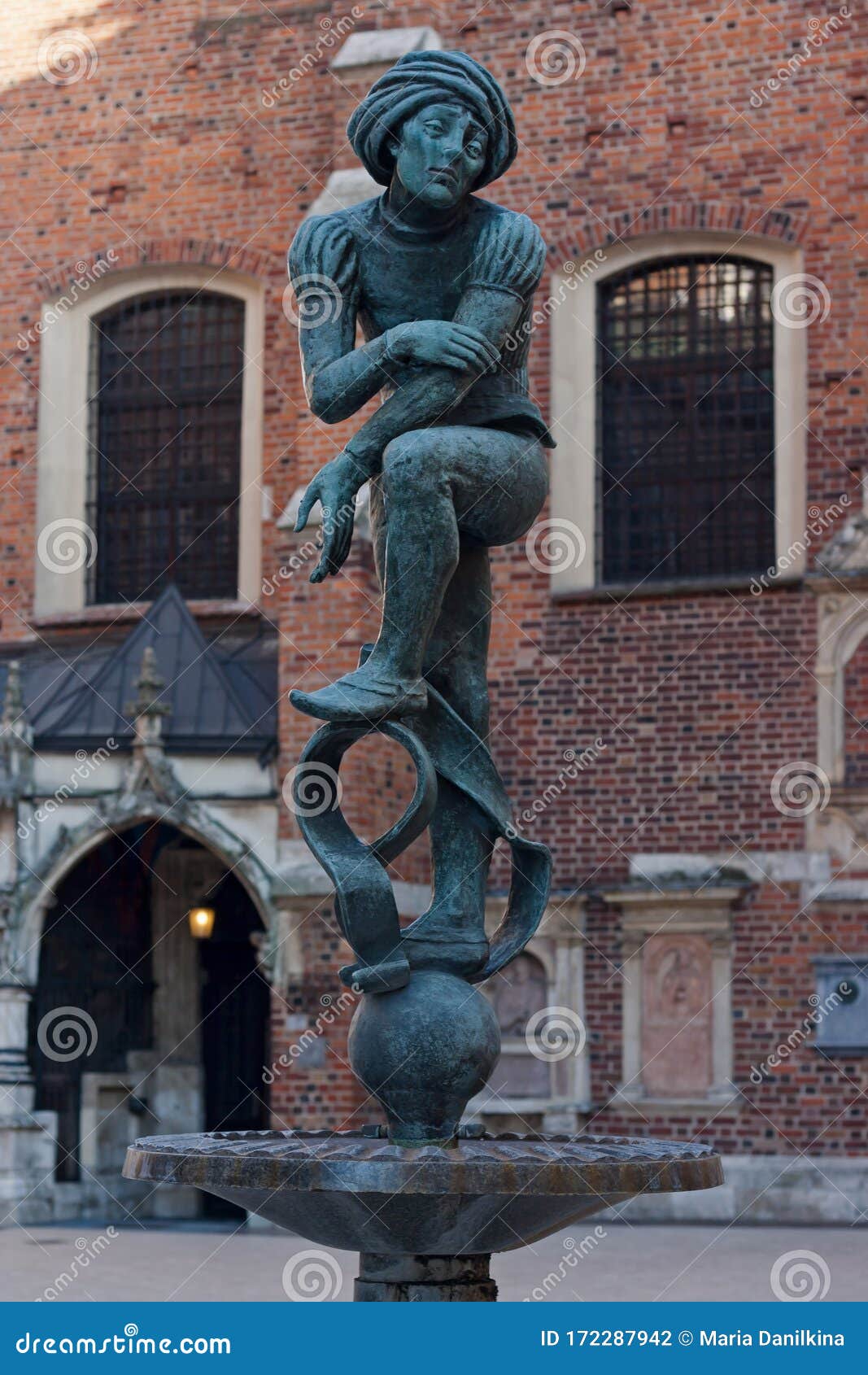 statue of student near saint mary church in krakow