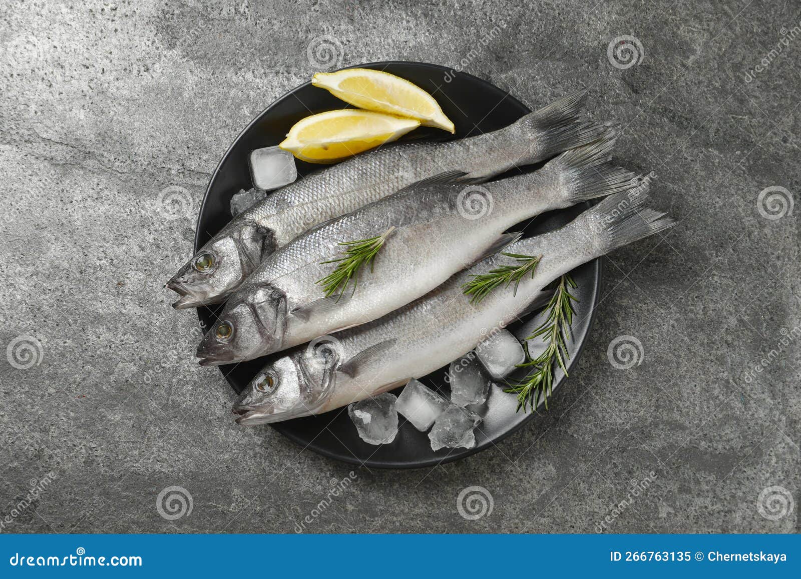 Sea Bass Fish and Ingredients on Grey Table, Top View Stock Image