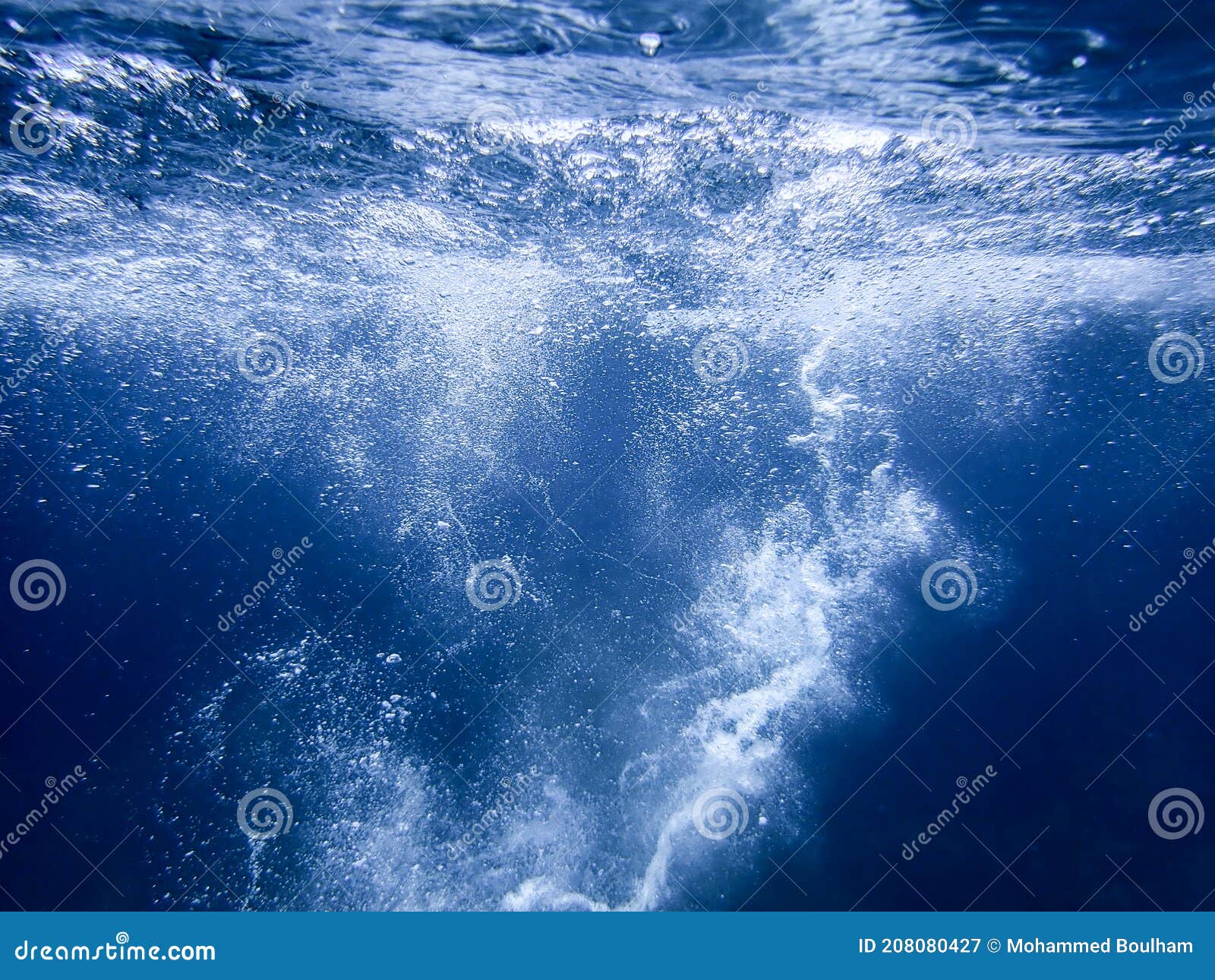 Sea Bubbles . Blue Sea Waves from Underwater with Bubbles. Light