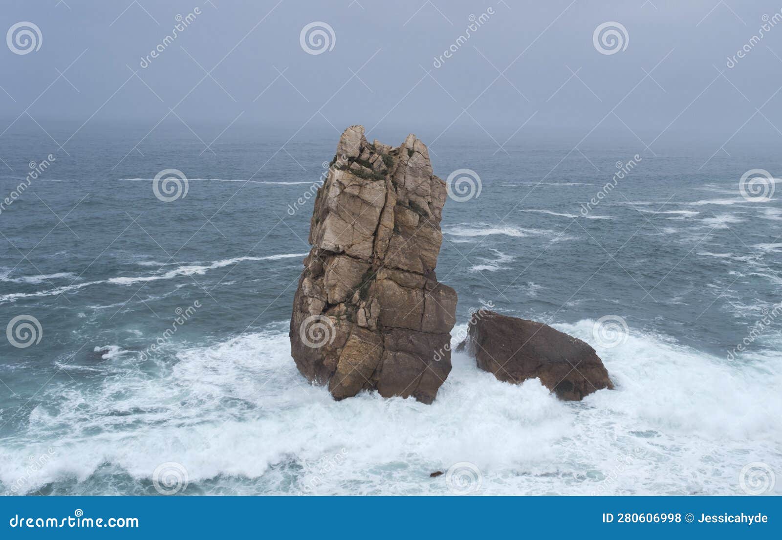 sea stacks carved out by wave action in the cantabrian coast with rough weather