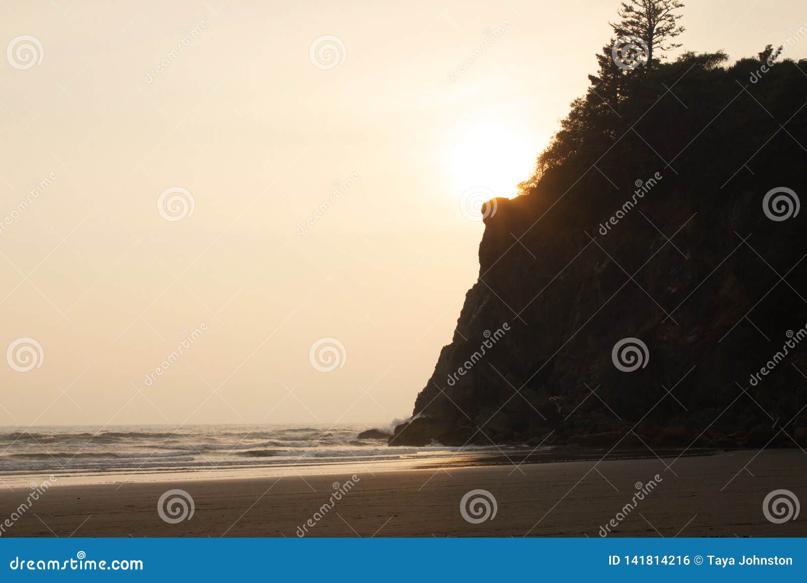 seastack blocks out sun last rays over pacific ocean