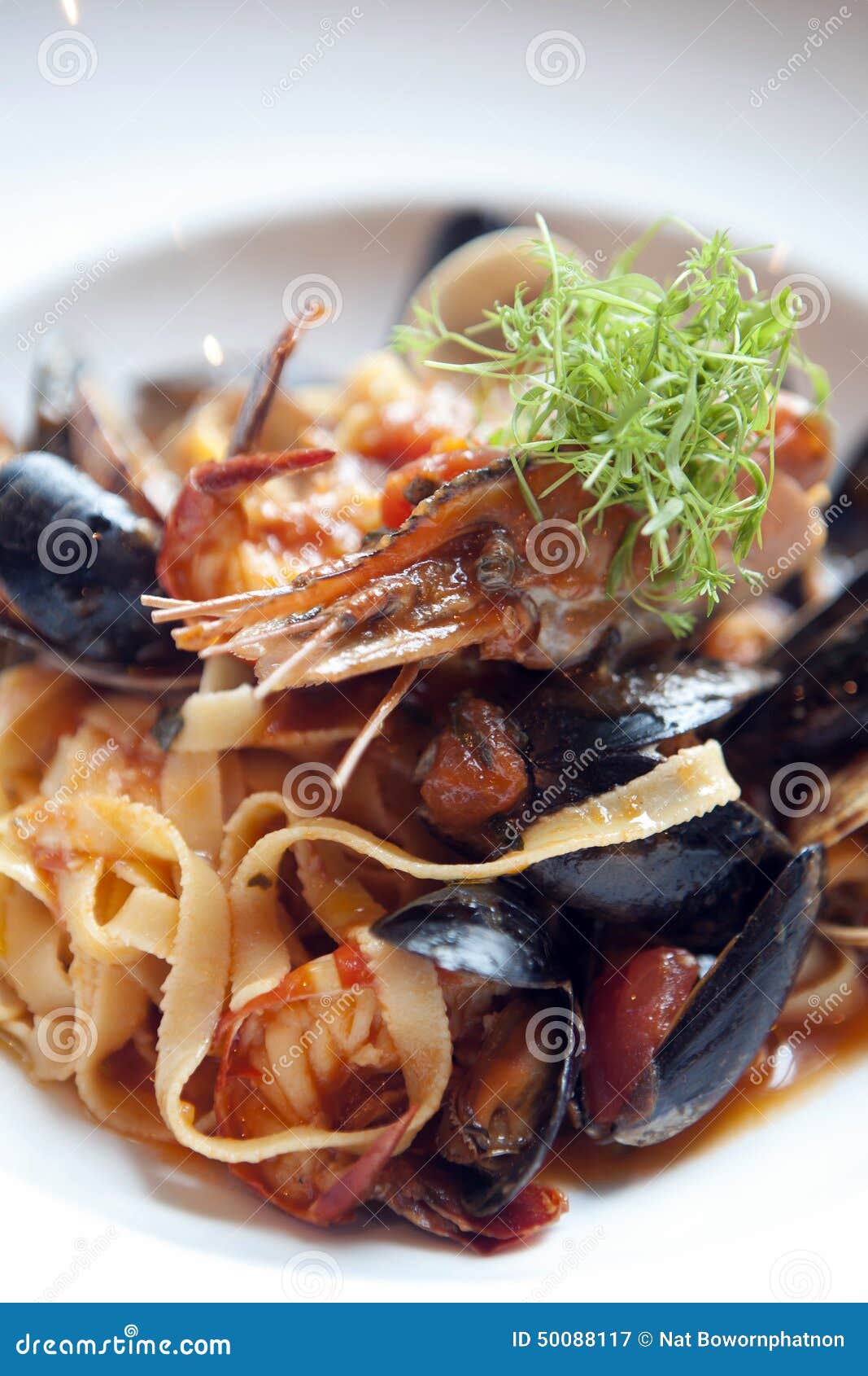 Seafood Pasta in Tomato Sauce Stock Image - Image of orange, green