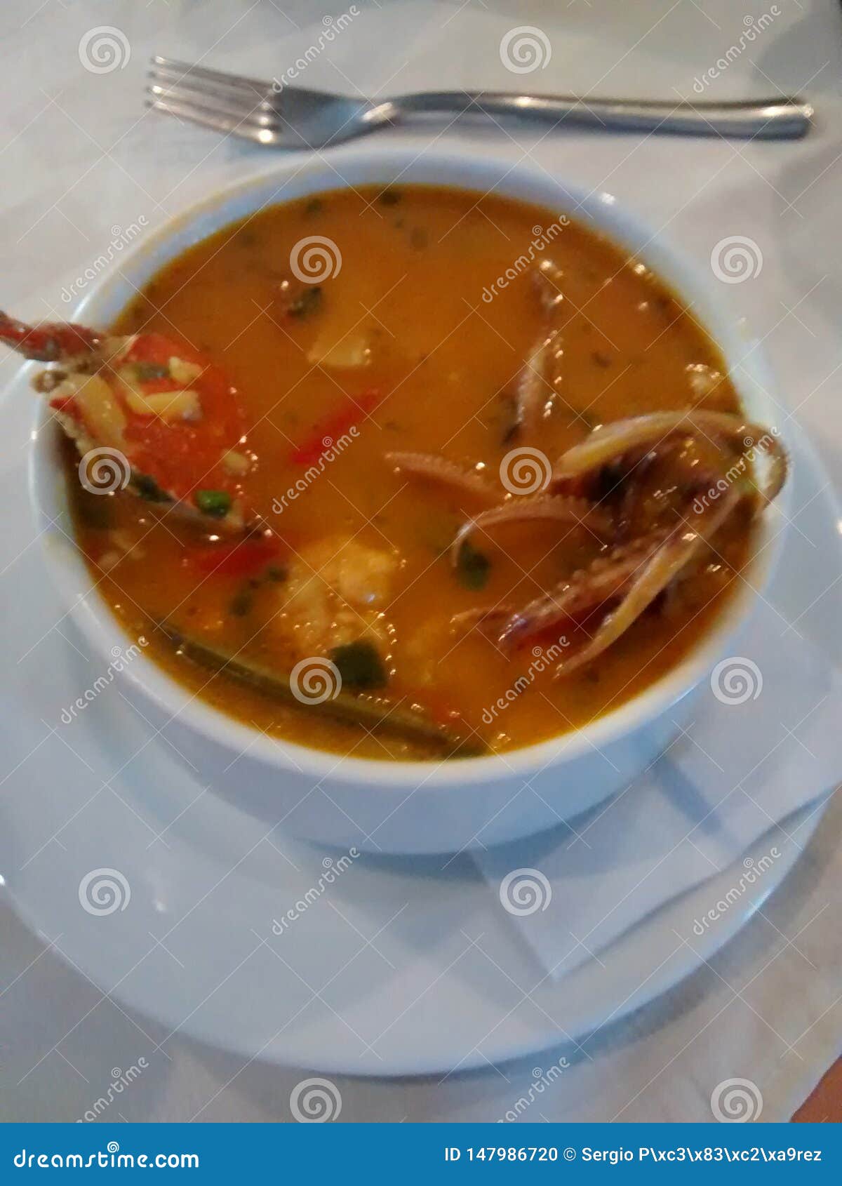 seafood soup in taza blanca in restaurant
