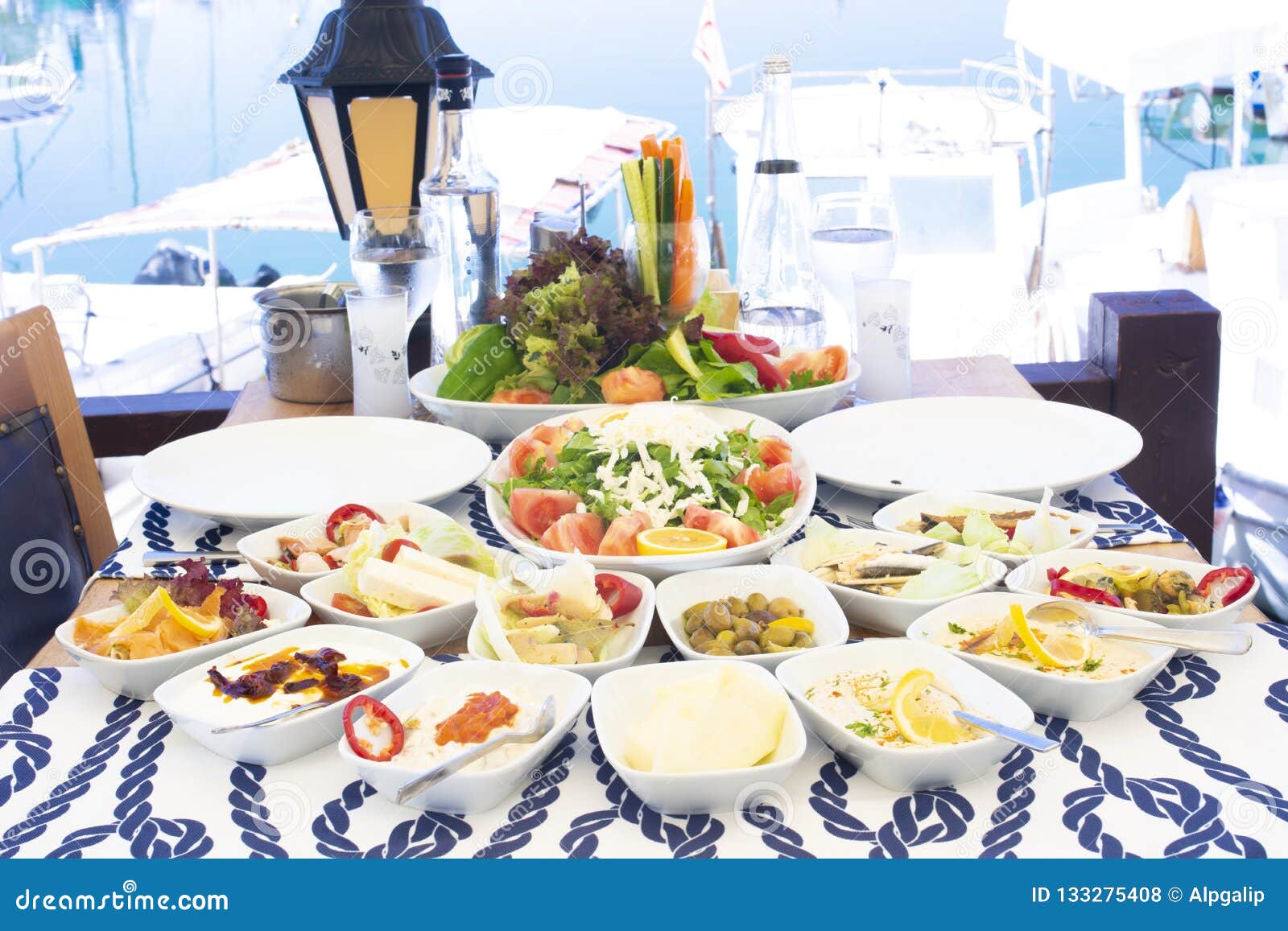 Seafoods, Fish, Salad And Mezes On The Table Near The Sea