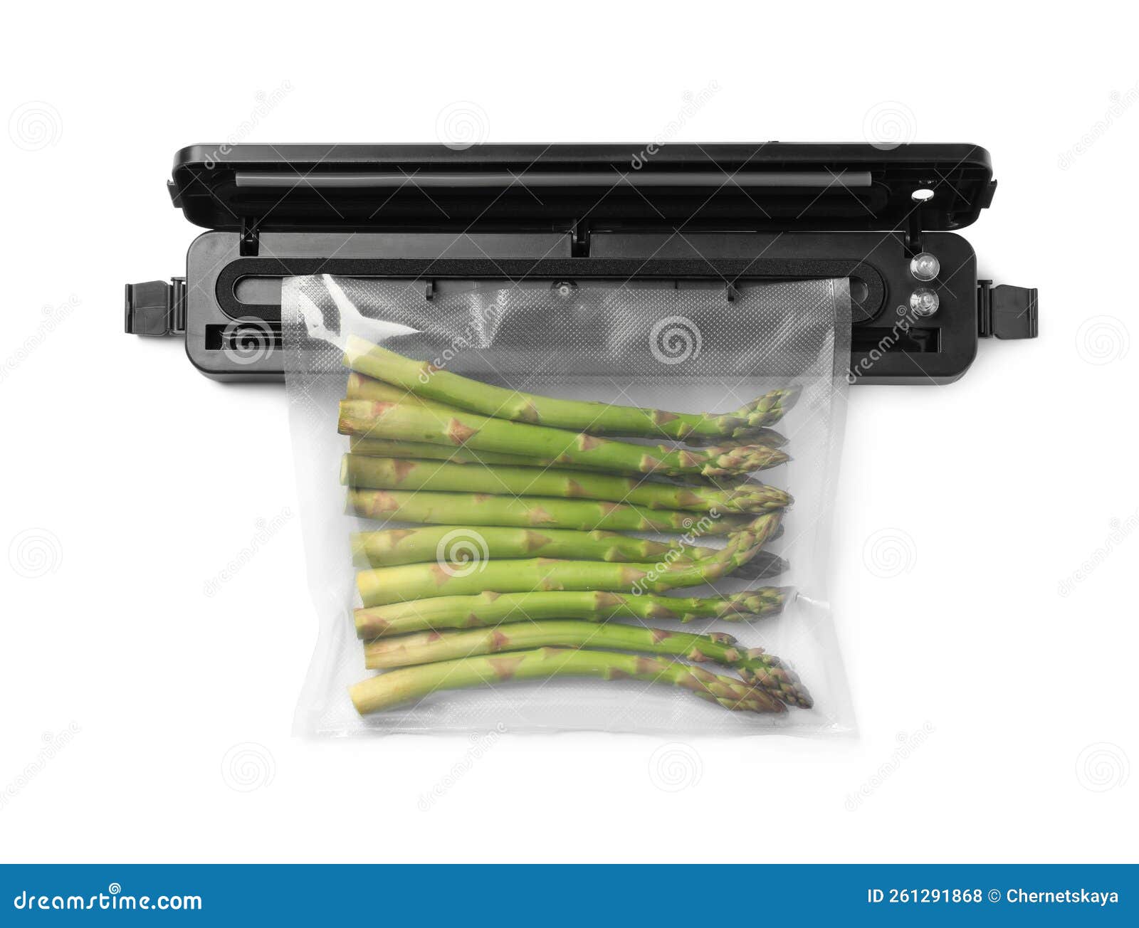 Sealer for Vacuum Packing with Plastic Bag of Asparagus on White Background, Top View Stock