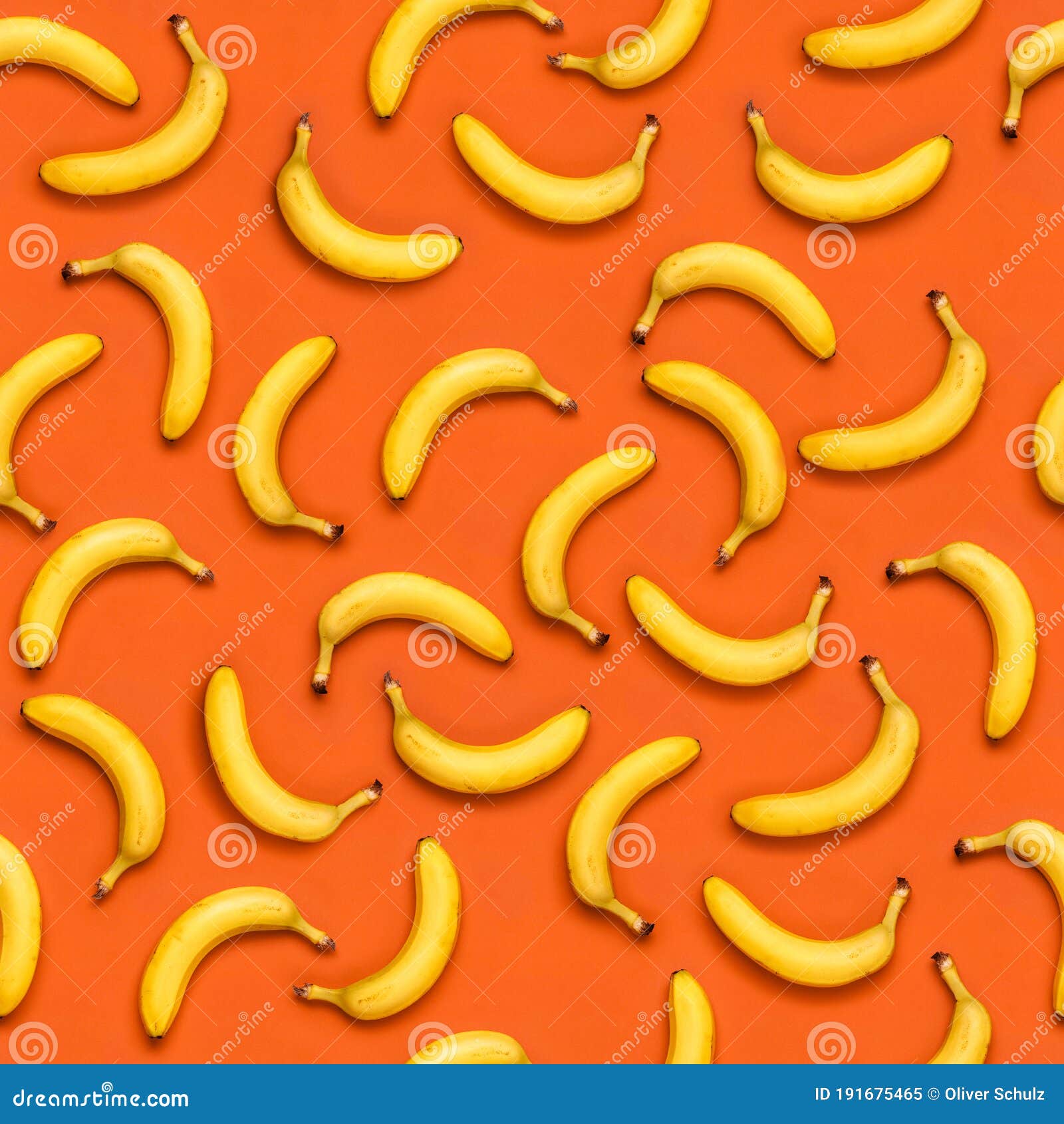 Seamless Banana Pattern with Random Oriented Banana Fruits on Orange