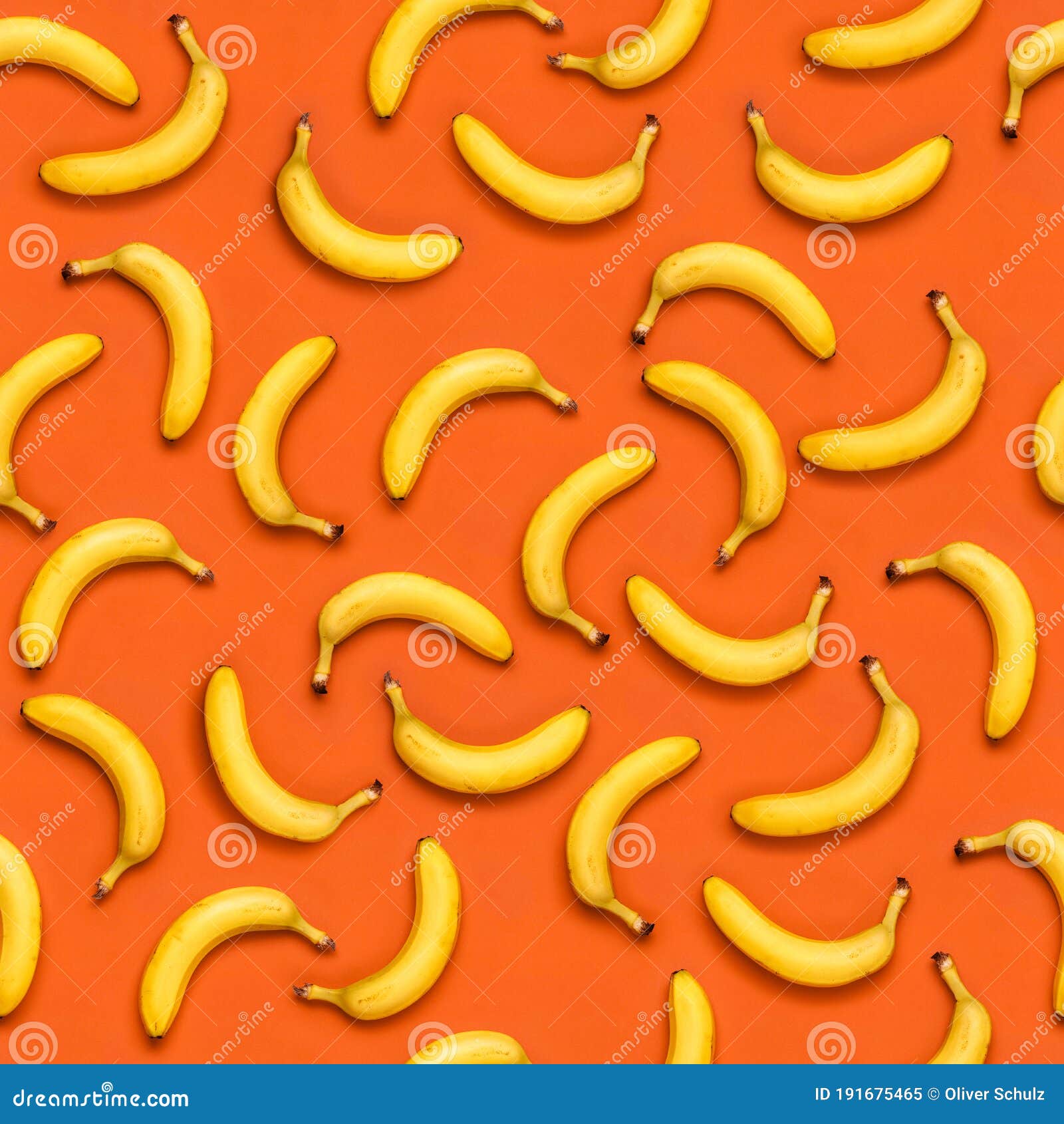 Seamless Banana Pattern With Random Oriented Banana Fruits On Orange