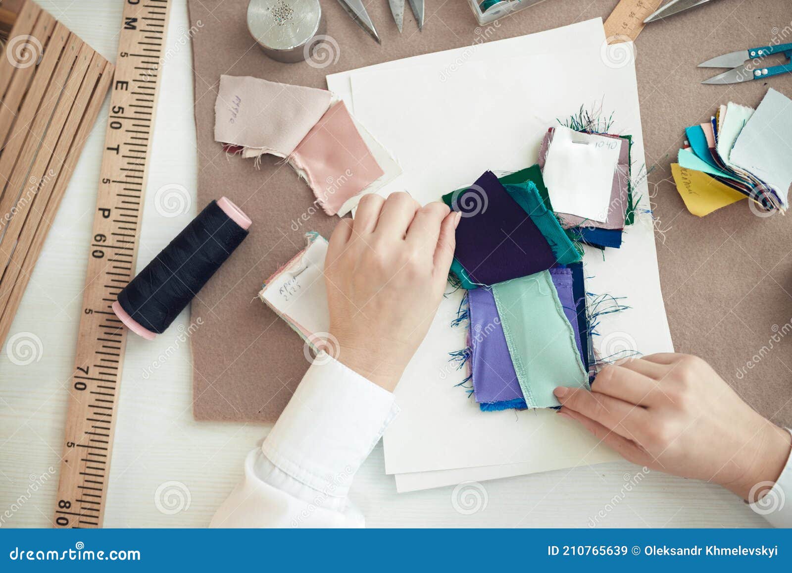 The Seamstress Chooses a Sample of Fabric for Sewing Clothes Stock
