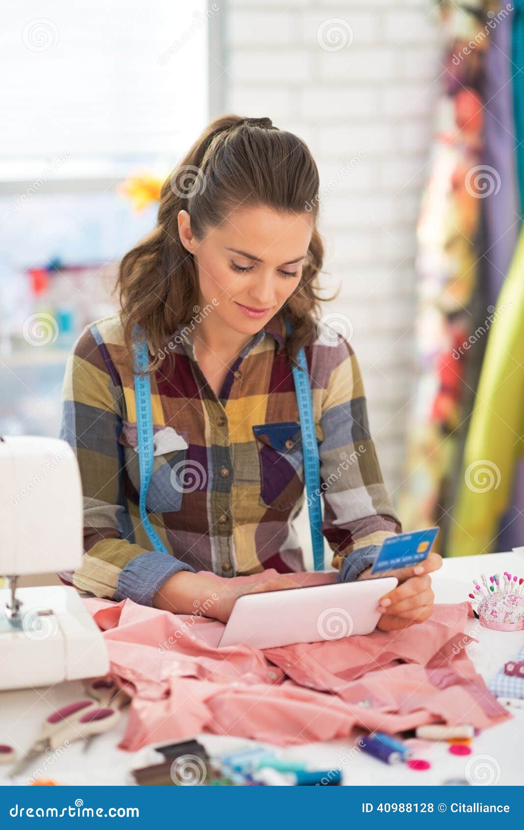 Seamstress with Credit Card Using Tablet Pc Stock Photo - Image of ...