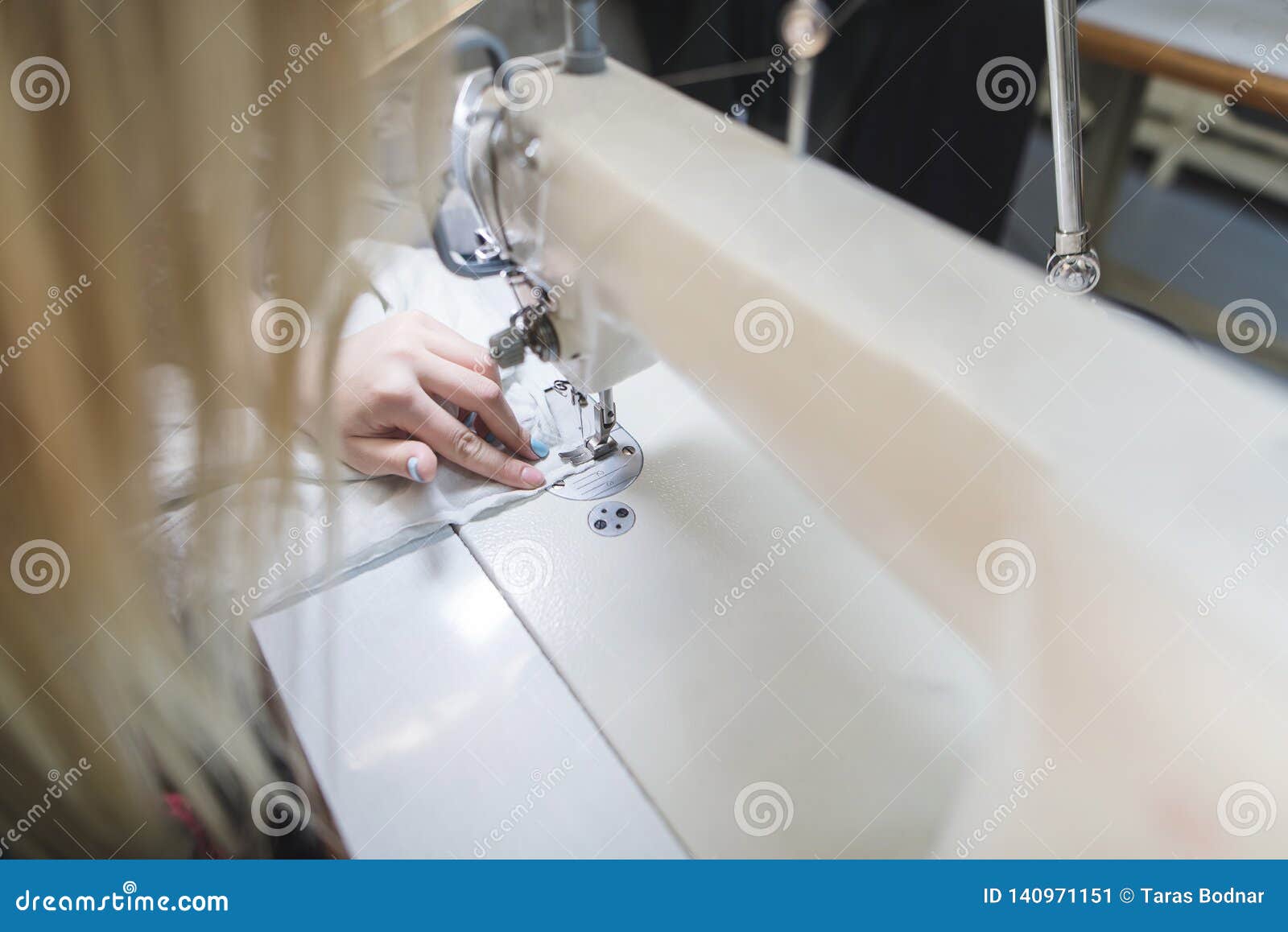Process of Work on a Car Washing Machine. Making Clothes on a Sewing