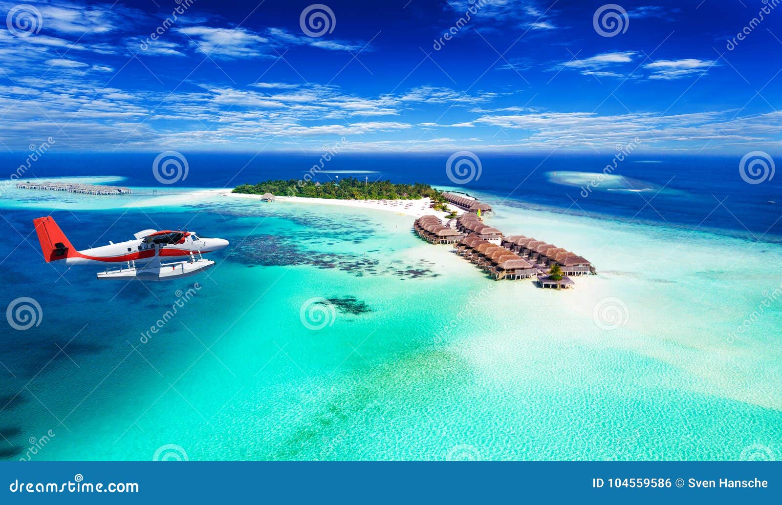 a seaplane approaching island in the maldives