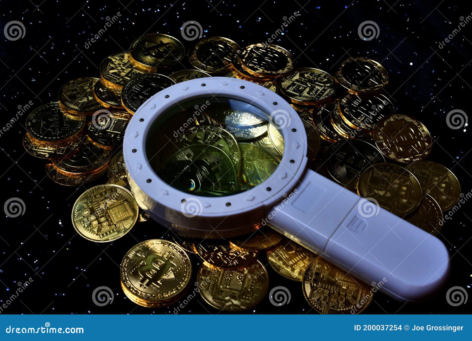 Magnifying glass with gold bar pile of gold coins under it Stock