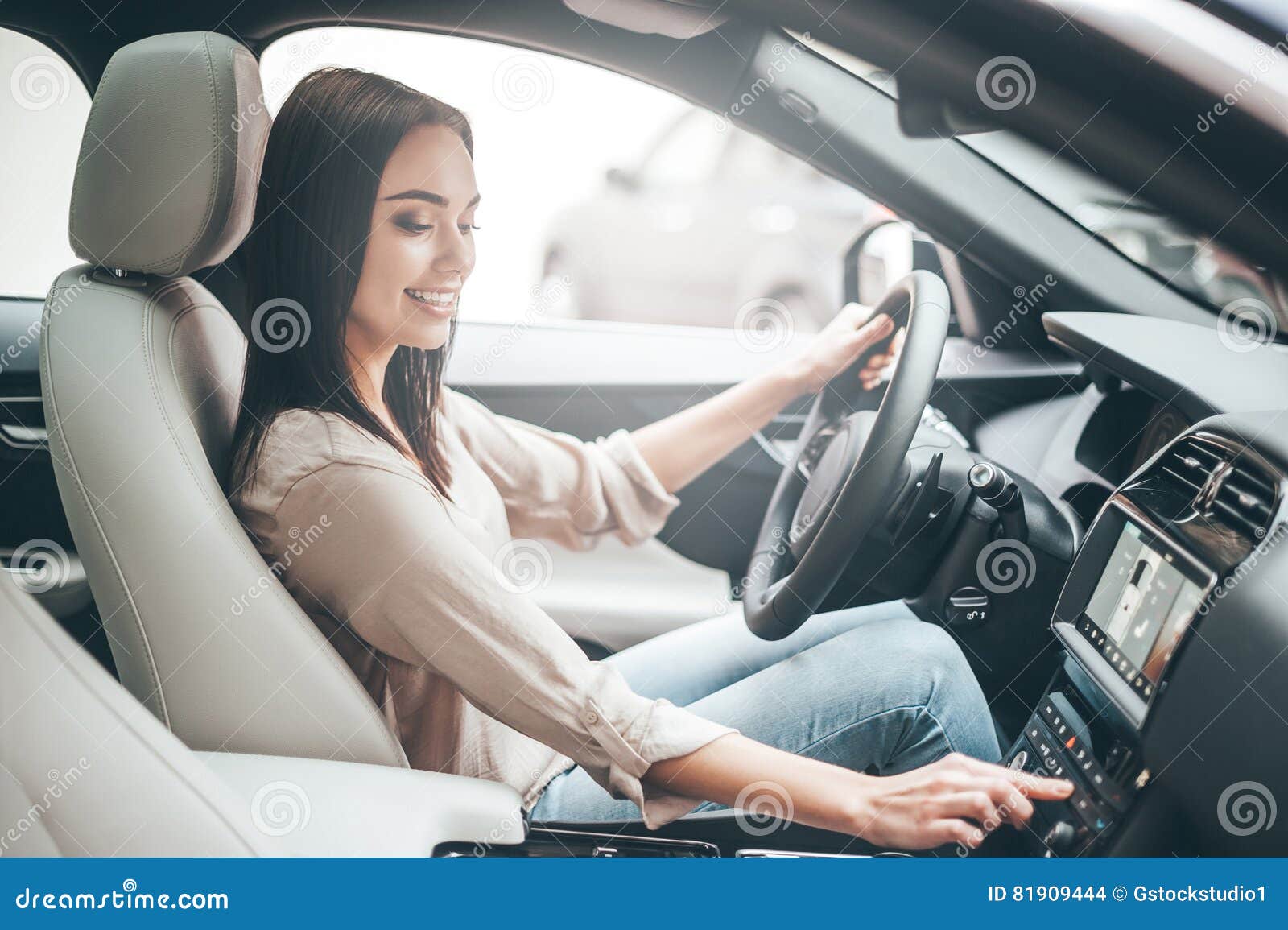 Woman Turning Button Of Radio In Car Stock Photo - Download Image