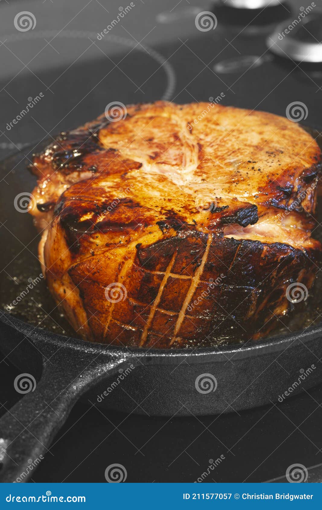 Searing a Glazed Gammon Ham Joint of Meat. Cast Iron Frying Pan on a ...