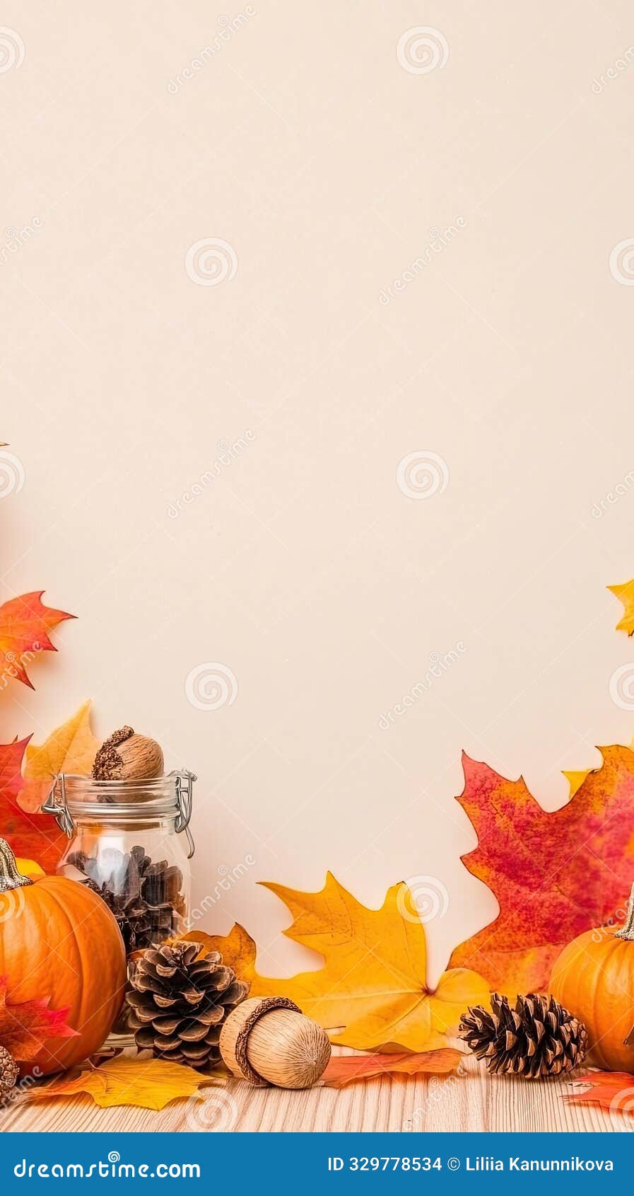 a seasonal display features autumn leaves, pinecones, and acorns arranged in a glass jar on a wooden table, capturing